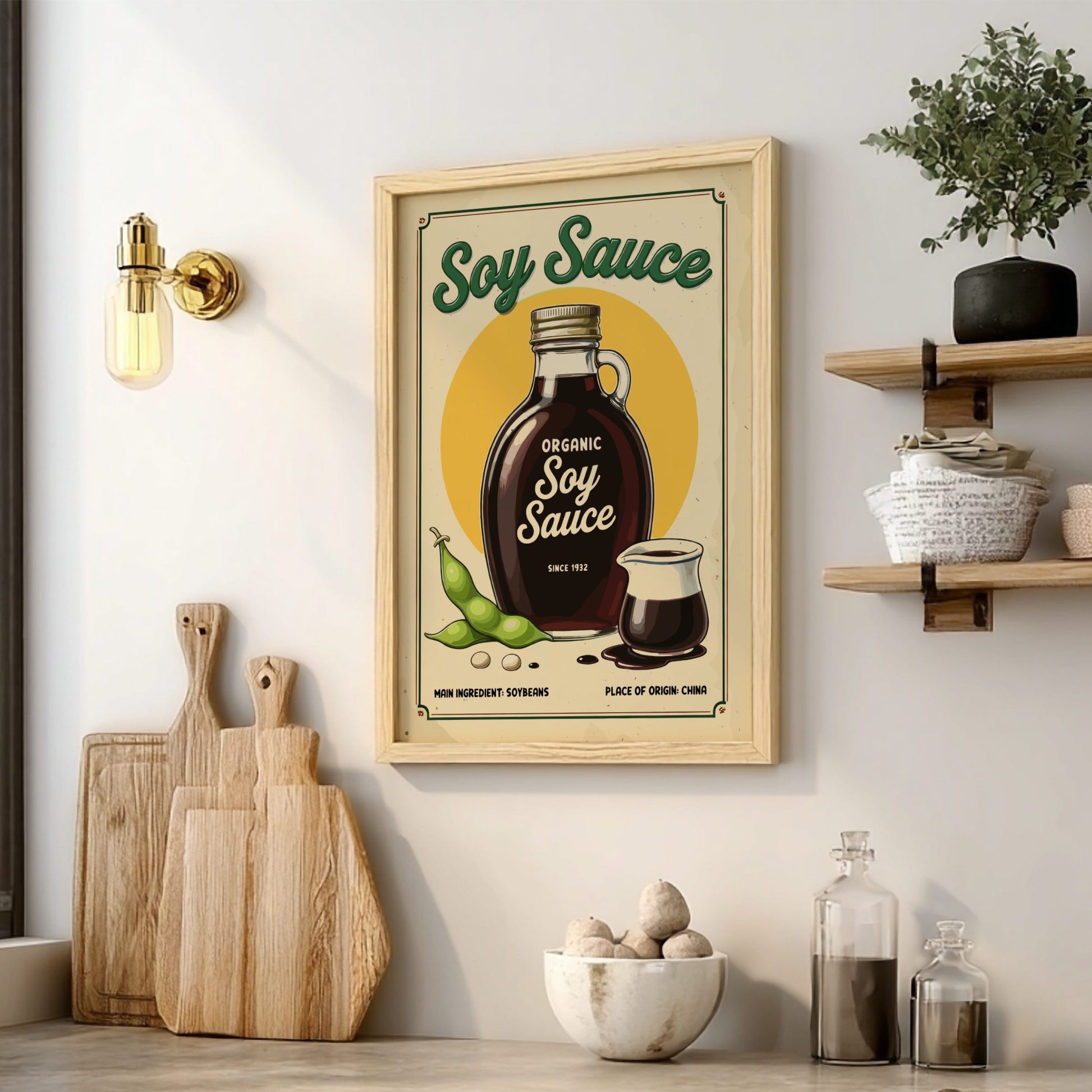 Framed poster of soy sauce bottle on a kitchen wall with cutting boards and bowls below.
