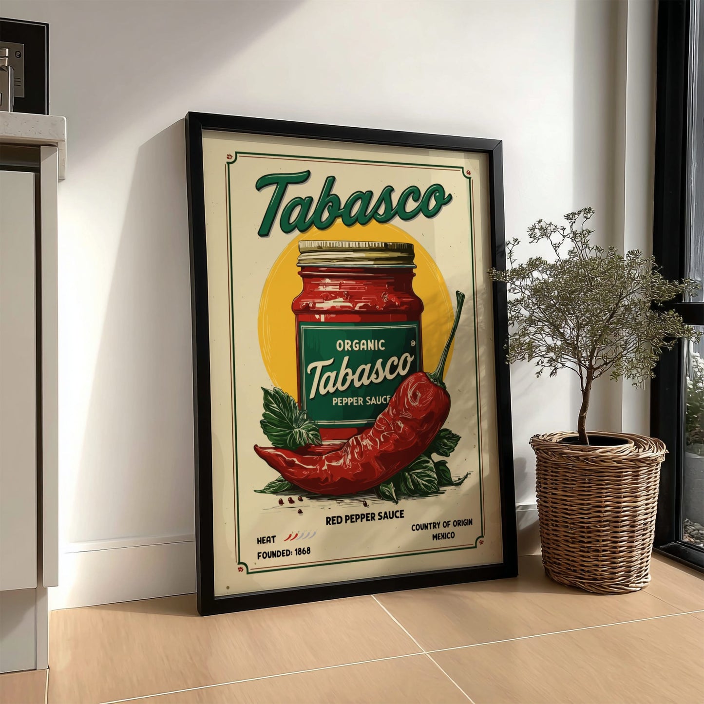 Framed Tabasco sauce poster on a wall next to a plant
