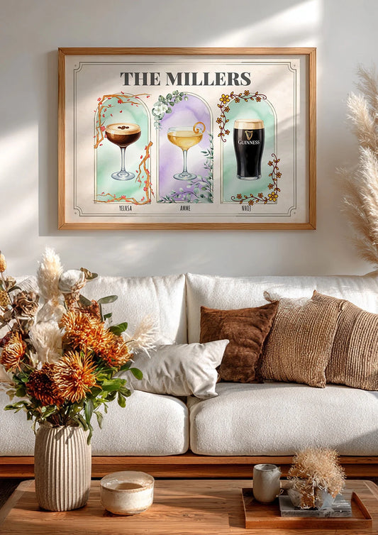 Framed artwork titled 'The Millers' above a white sofa with decorative pillows and a vase of flowers.