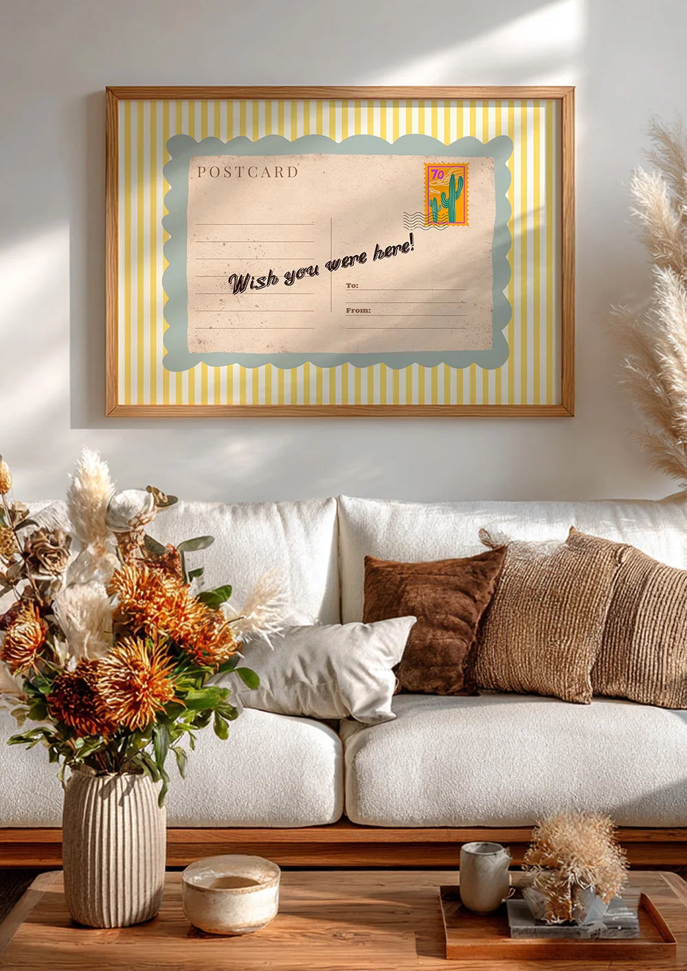 Framed postcard with 'Wish you were here!' text in a living room setting.