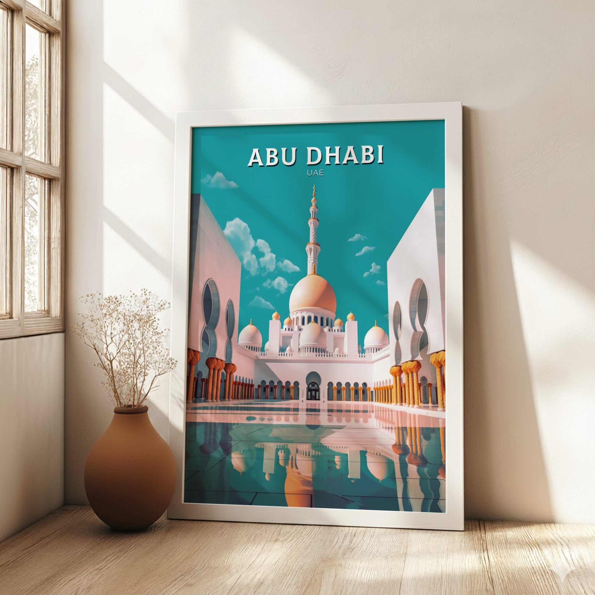 Framed poster of Abu Dhabi with a mosque illustration in a room with a vase and plant.