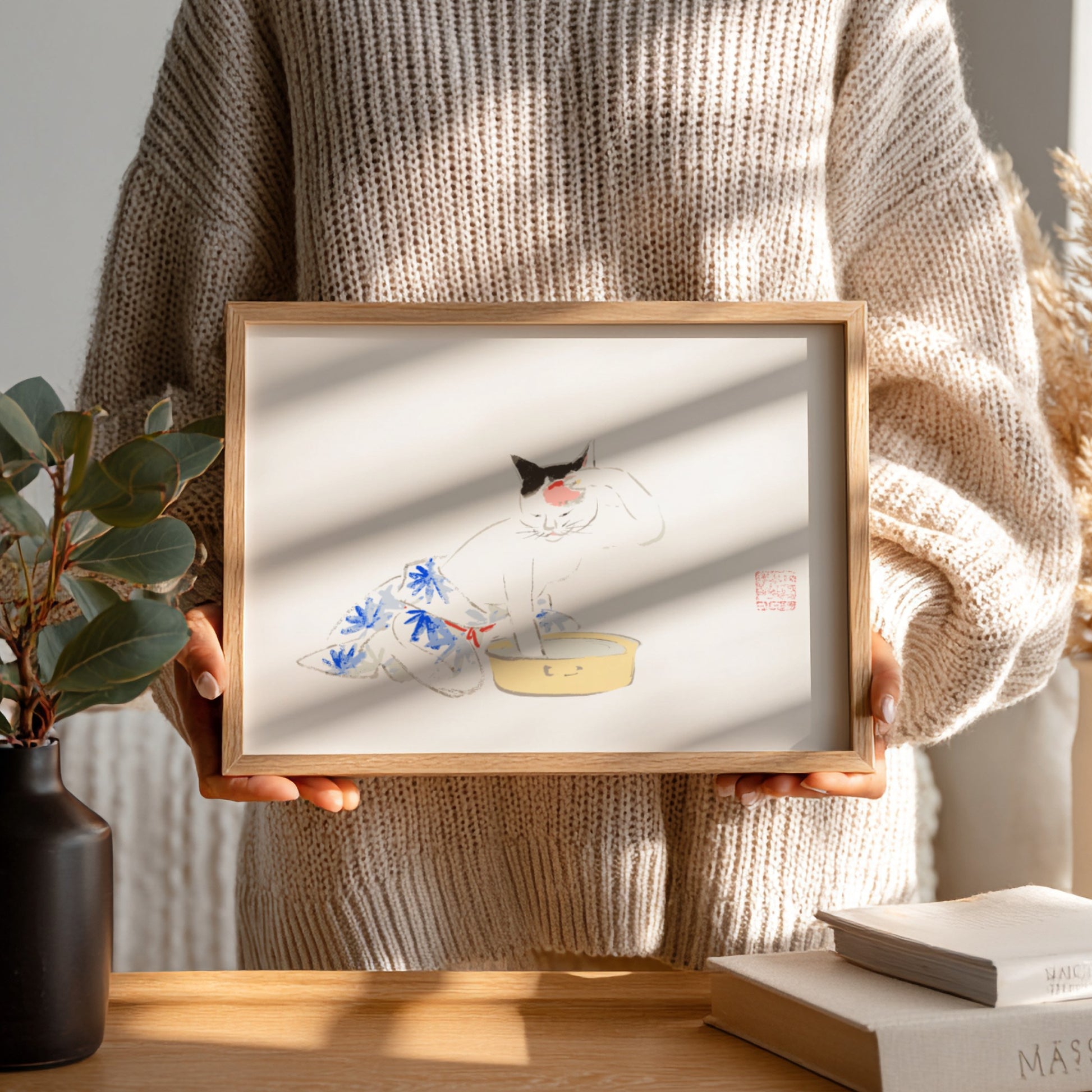 Japanese art poster featuring a playful cat illustration with floral patterns in soft colors.