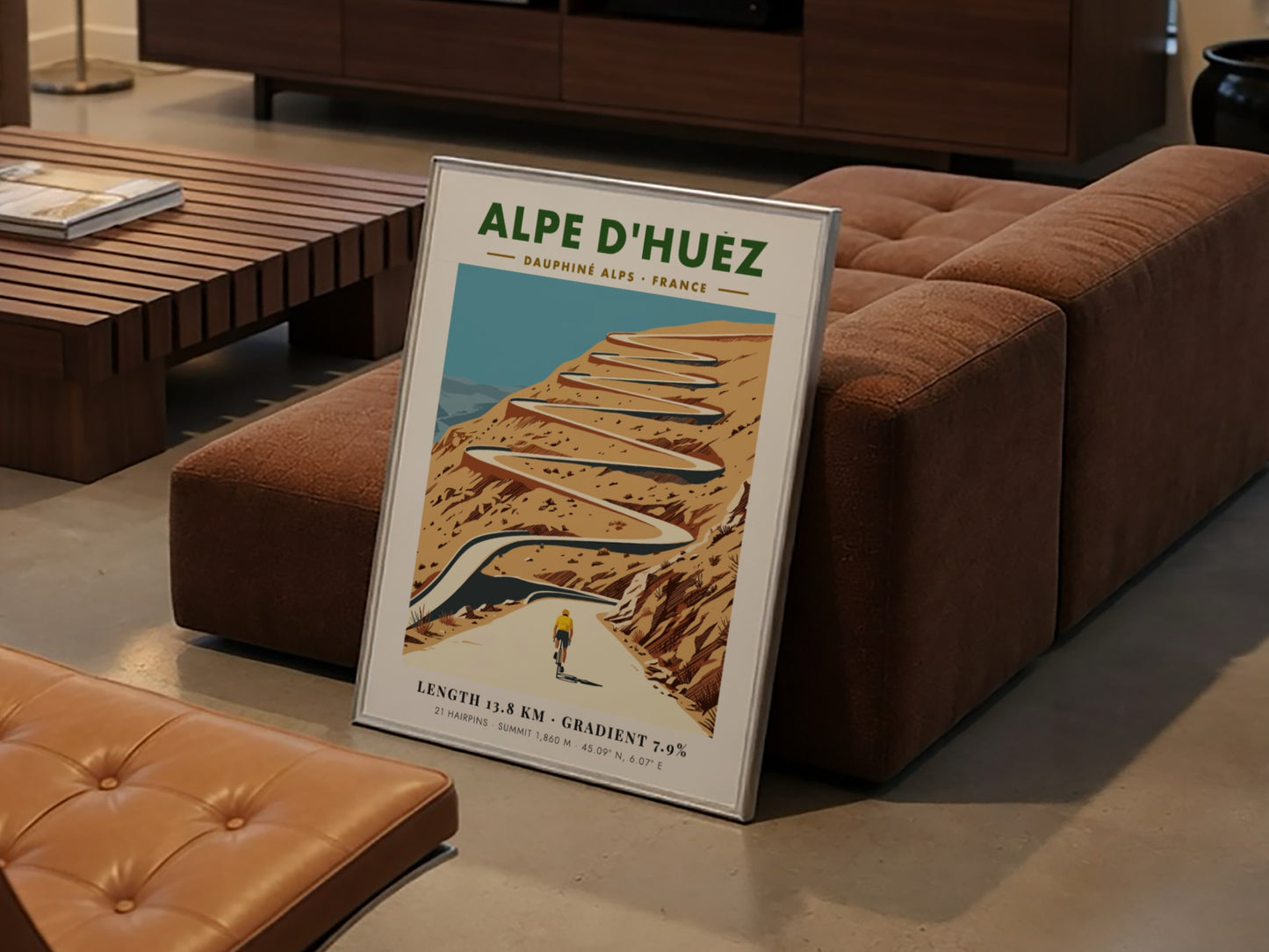 Poster featuring a lone cyclist climbing the winding Alpe D'Huez road in France.