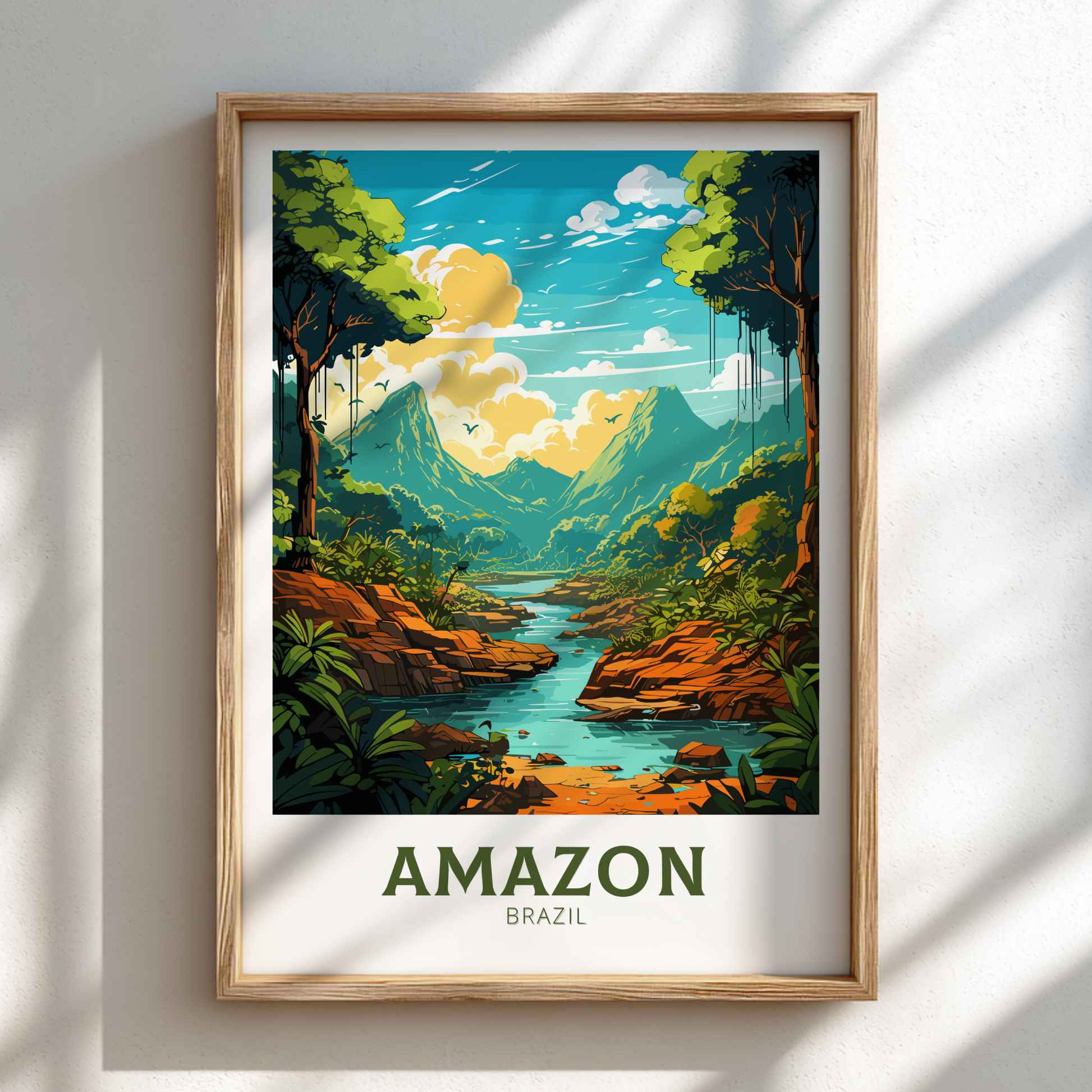 Framed artwork of the Amazon rainforest with a river and mountains on a white wall.