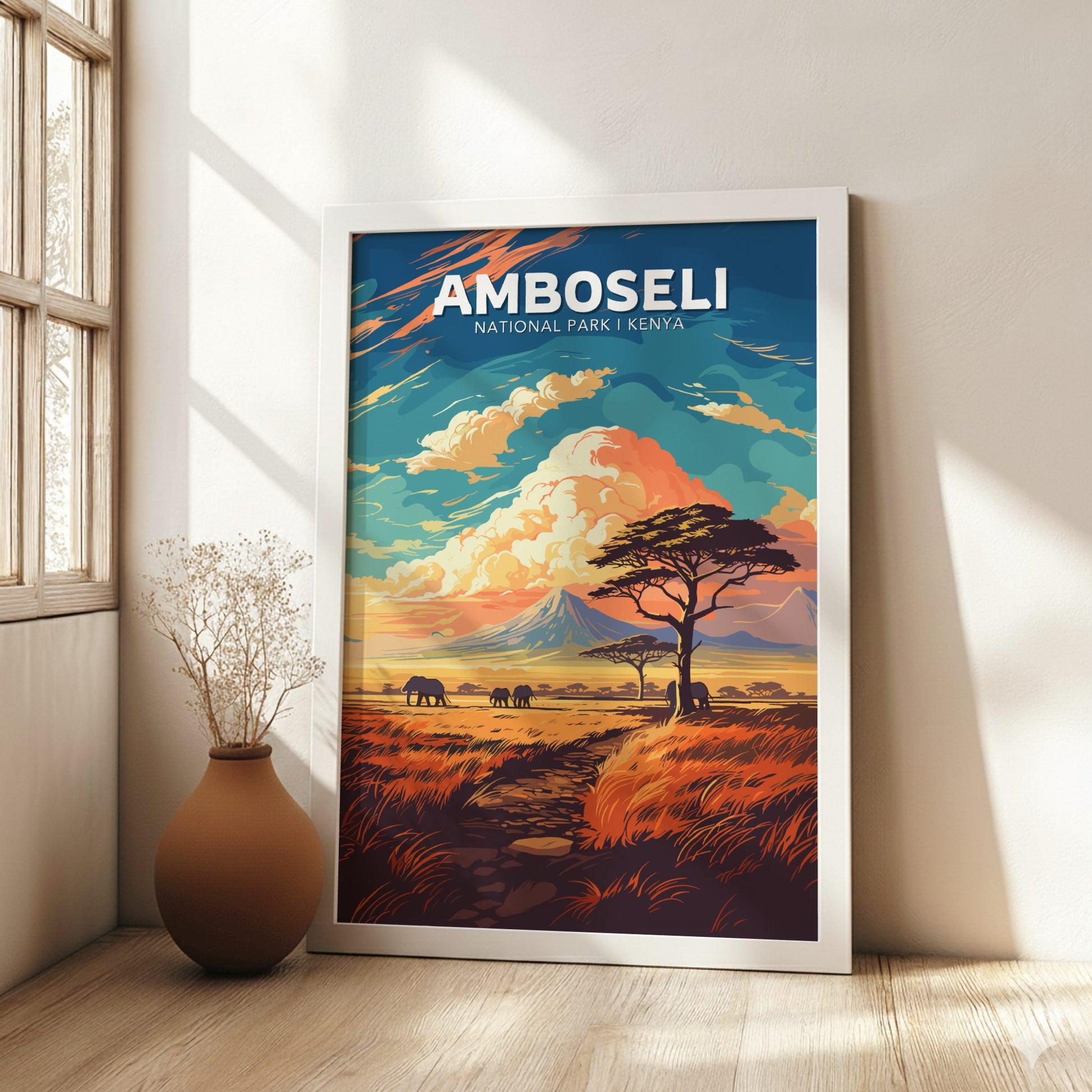 Framed artwork of Amboseli National Park, Kenya, in a room with a vase and window.