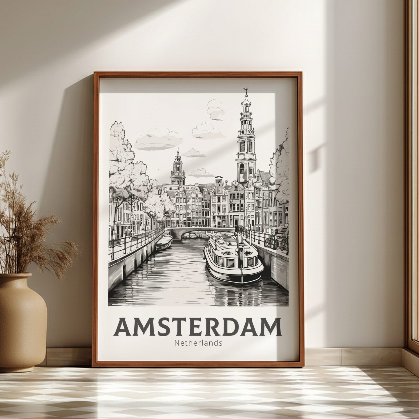 Framed artwork of Amsterdam with a boat on a canal, placed on a light wooden floor.