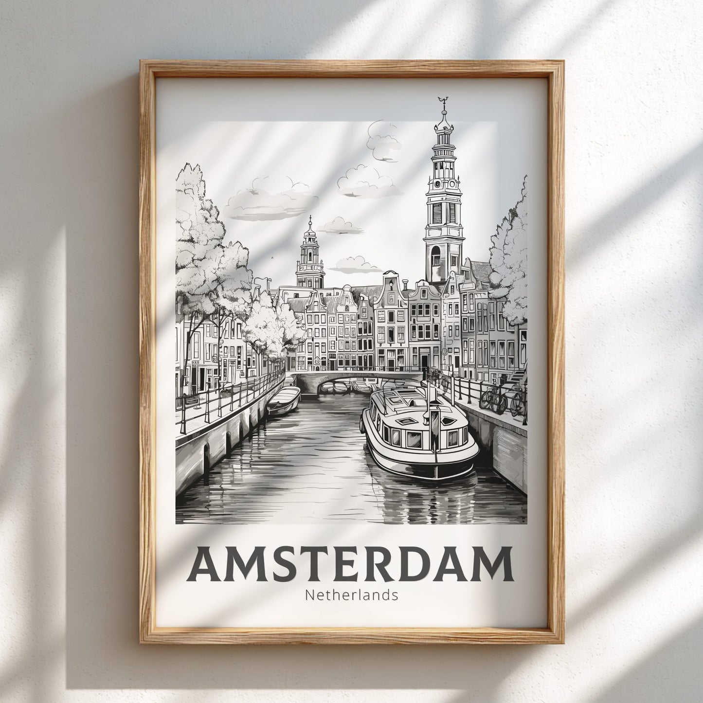 Framed artwork of Amsterdam with a canal and boat, labeled 'Amsterdam, Netherlands'.