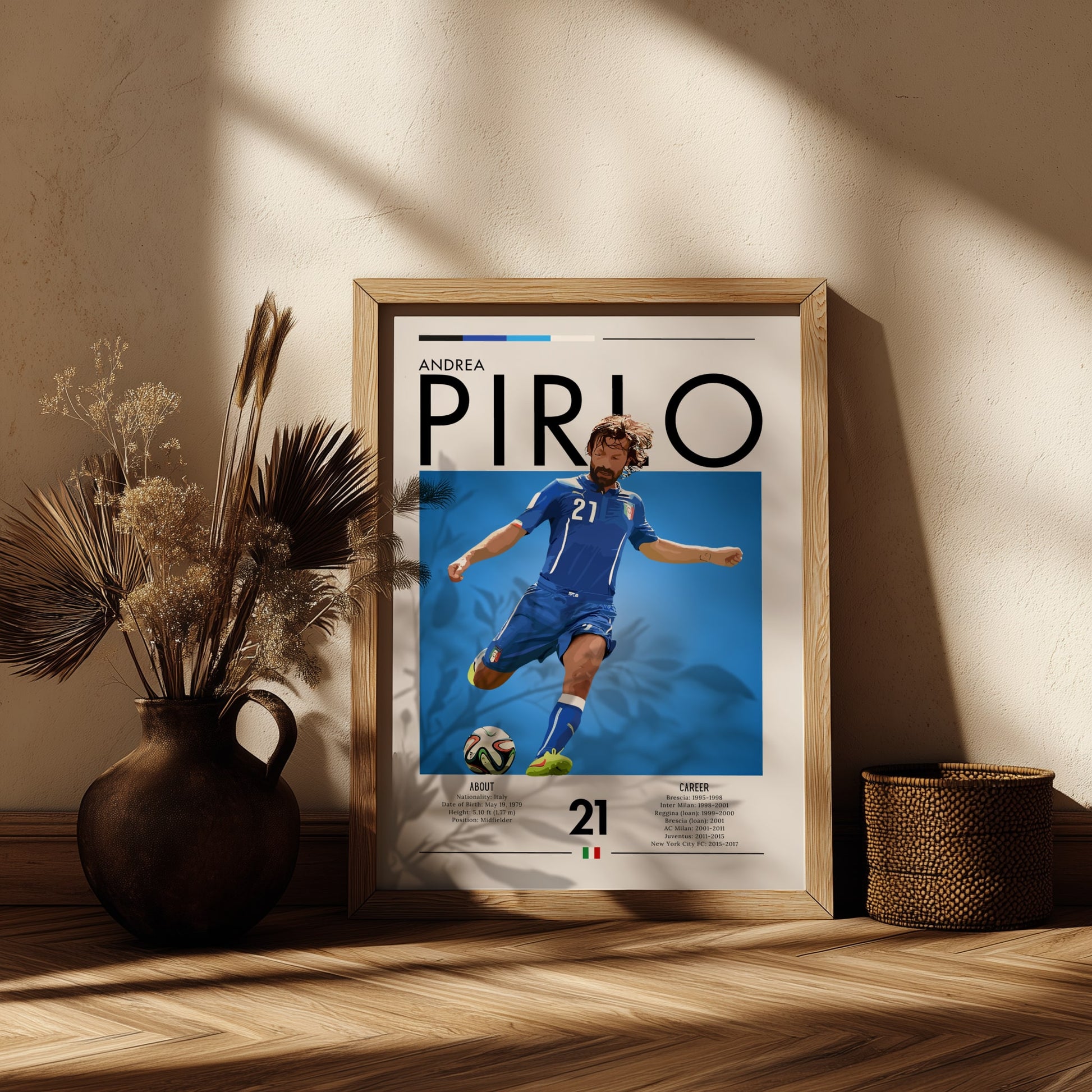 Framed poster of Andrea Pirlo on a wooden shelf with decorative plants.