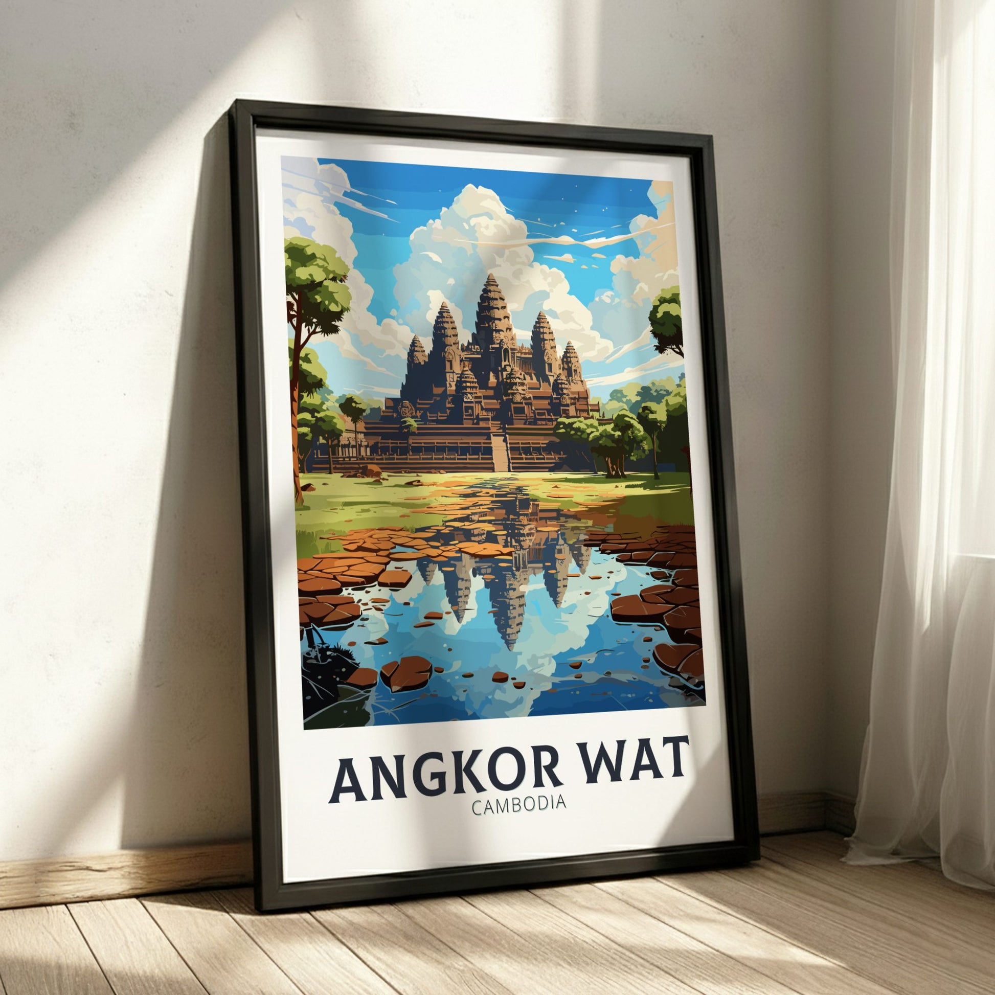 Framed poster of Angkor Wat with a temple reflection in water on a white wall.