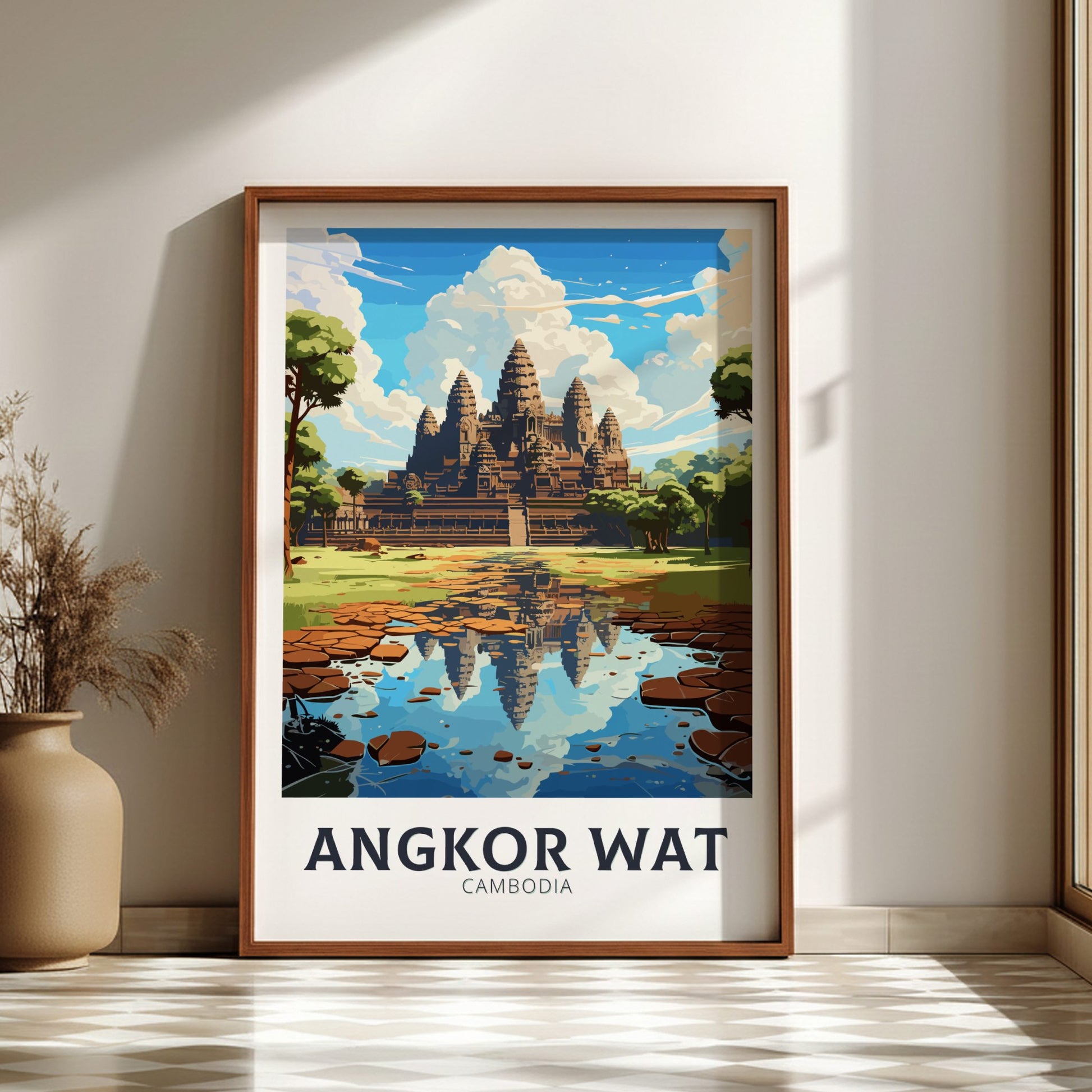 Framed poster of Angkor Wat with a wooden frame on a wall.