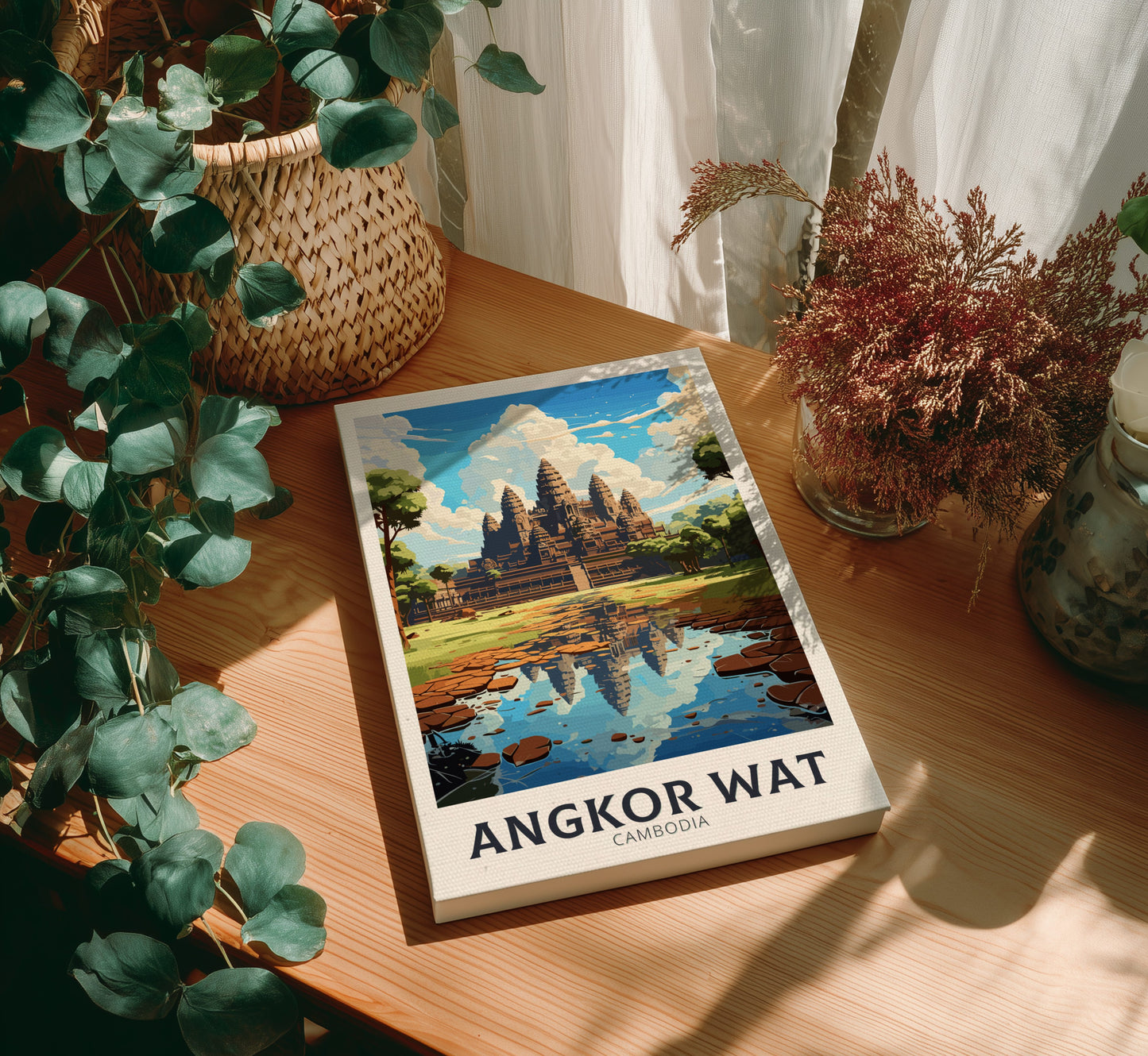 Canvas 'Angkor Wat' on a wooden table with plants around