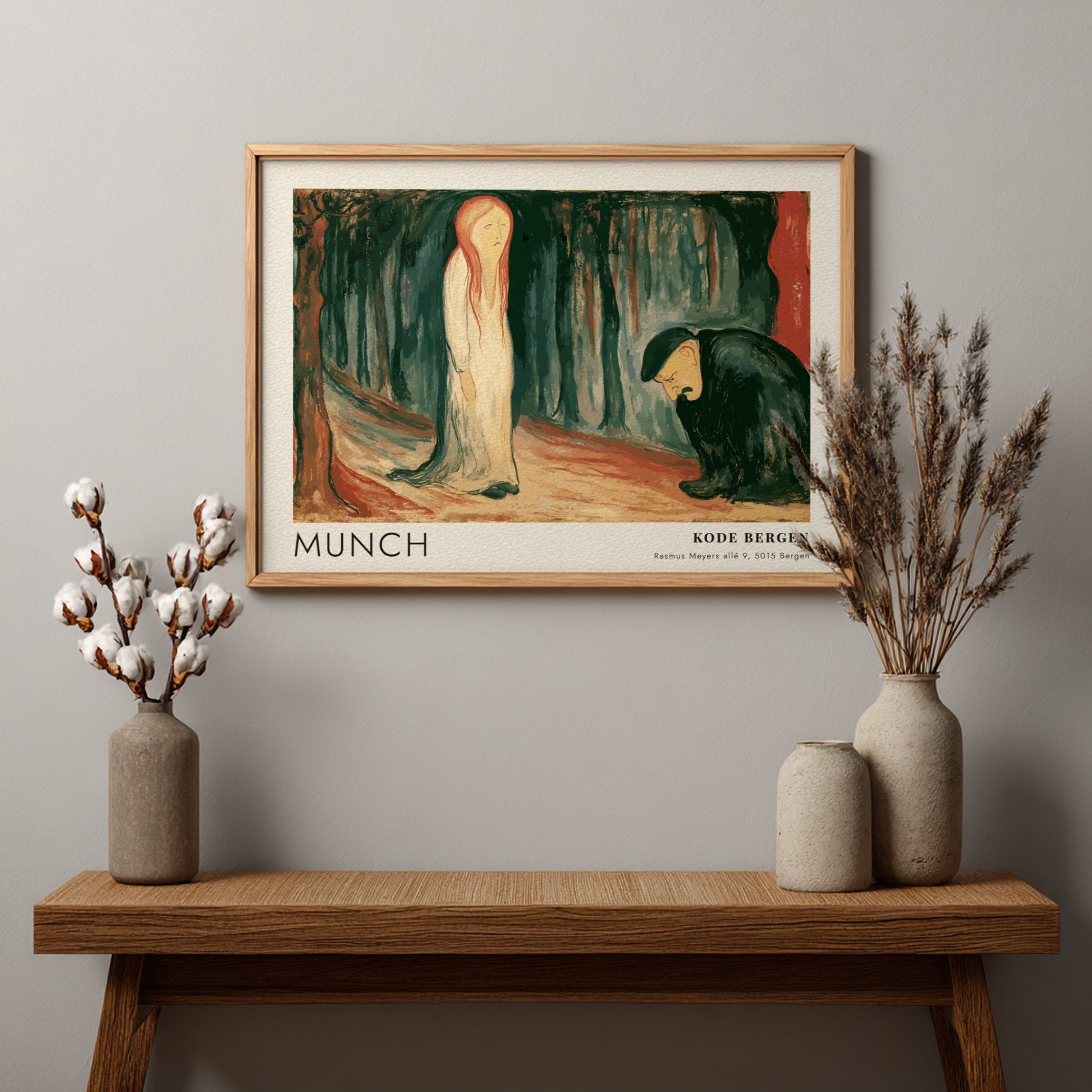 Exhibition poster featuring Edvard Munch's Ashes painting in a light wooden frame hanging