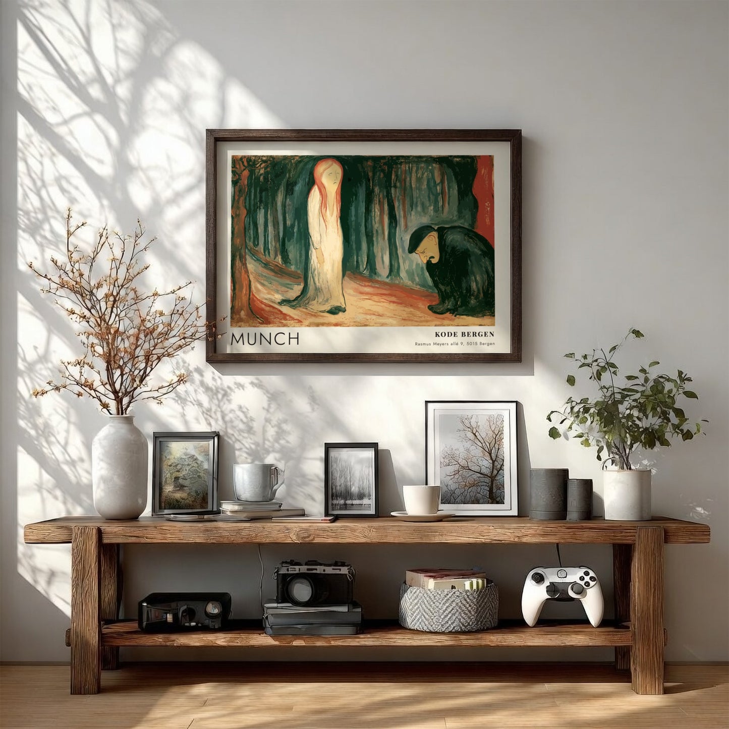 Exhibition poster featuring Edvard Munch's Ashes painting in a light wooden frame hanging