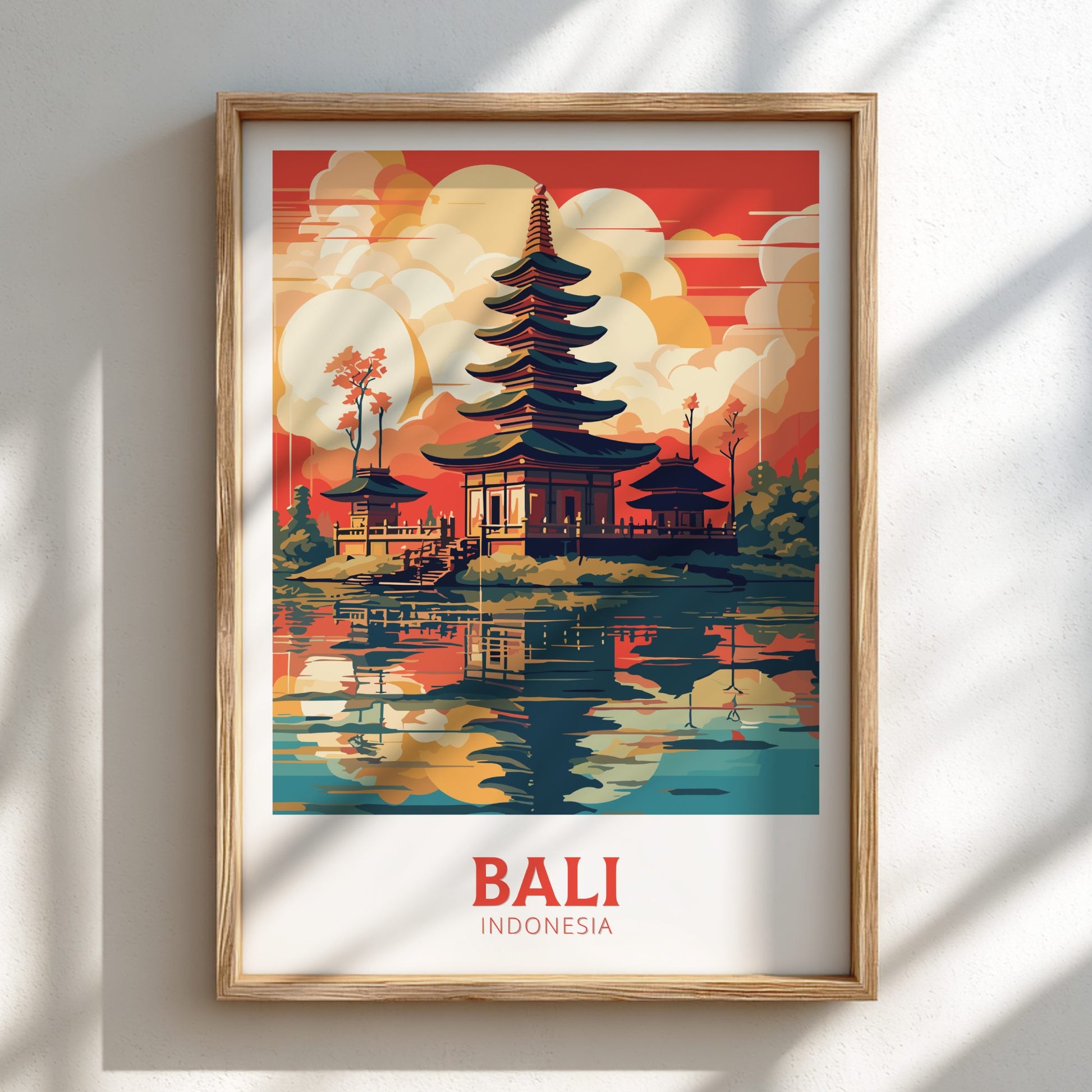 Framed artwork of a temple in Bali, Indonesia with a colorful sunset background.