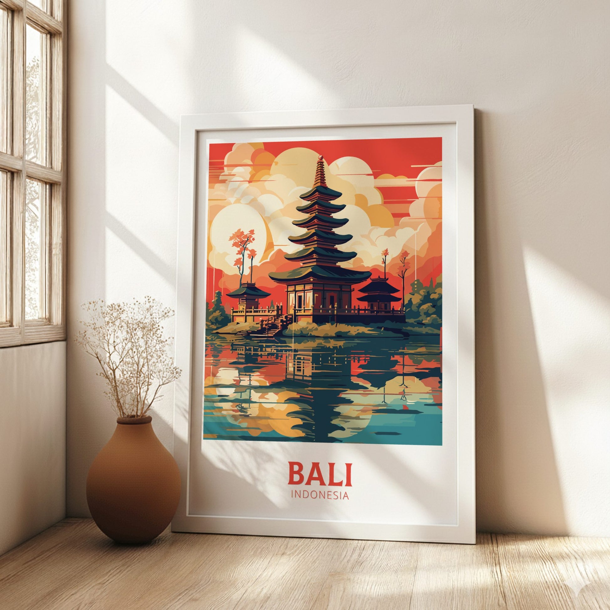 Framed poster of Bali, Indonesia with a temple design in a room with a vase and window.