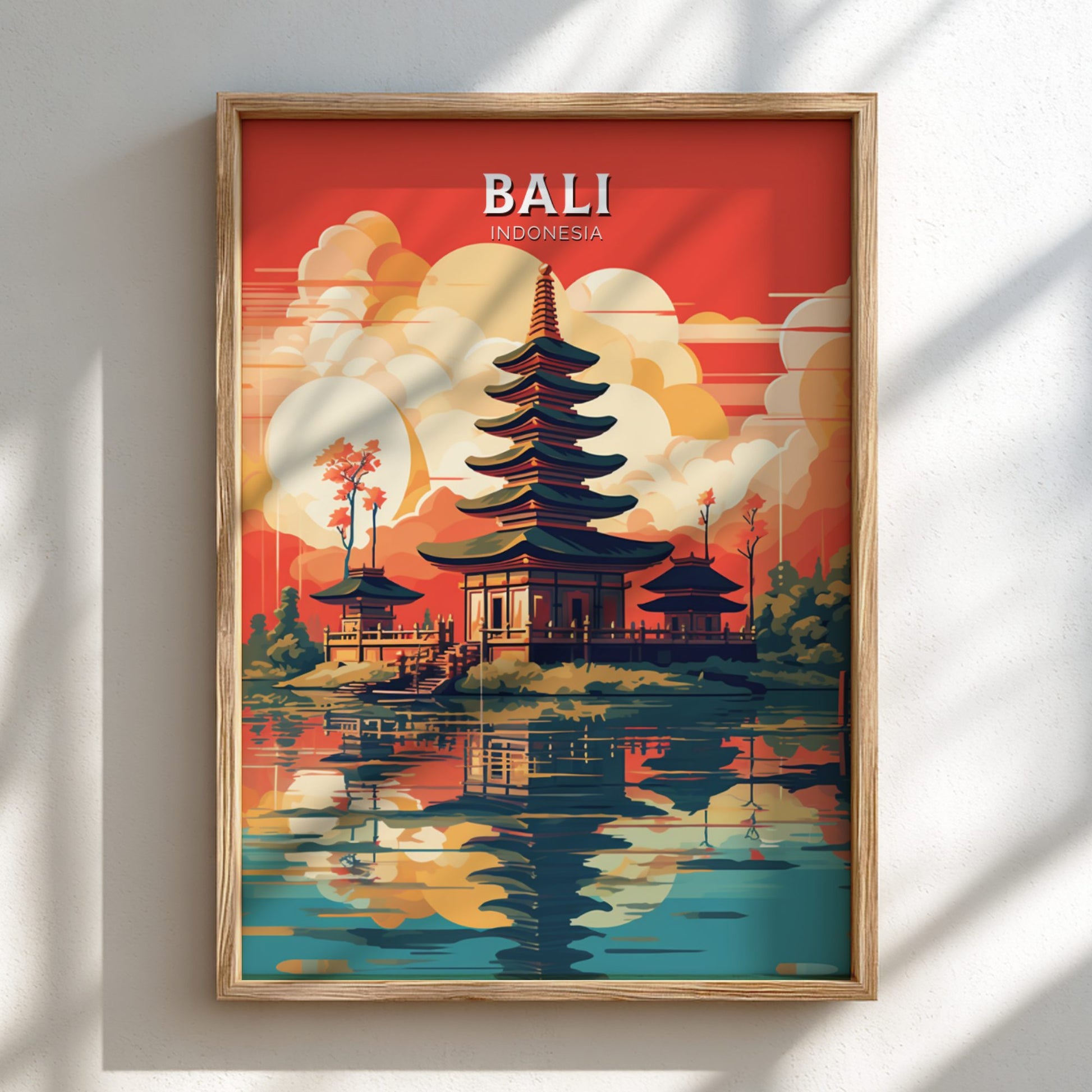 Framed artwork of a temple in Bali, Indonesia with a colorful sunset background.