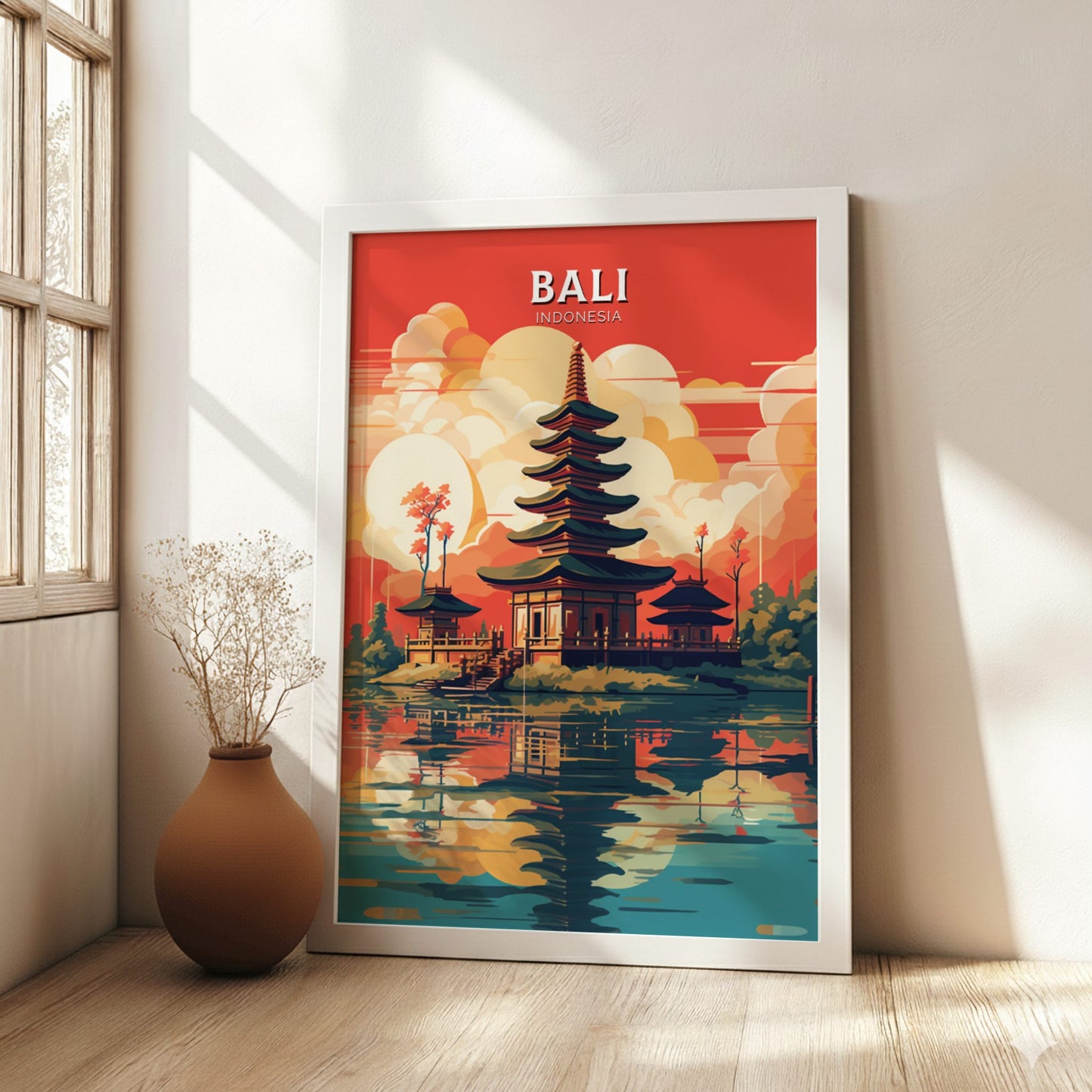 Framed poster of Bali, Indonesia with a temple design in a room with a vase and window.