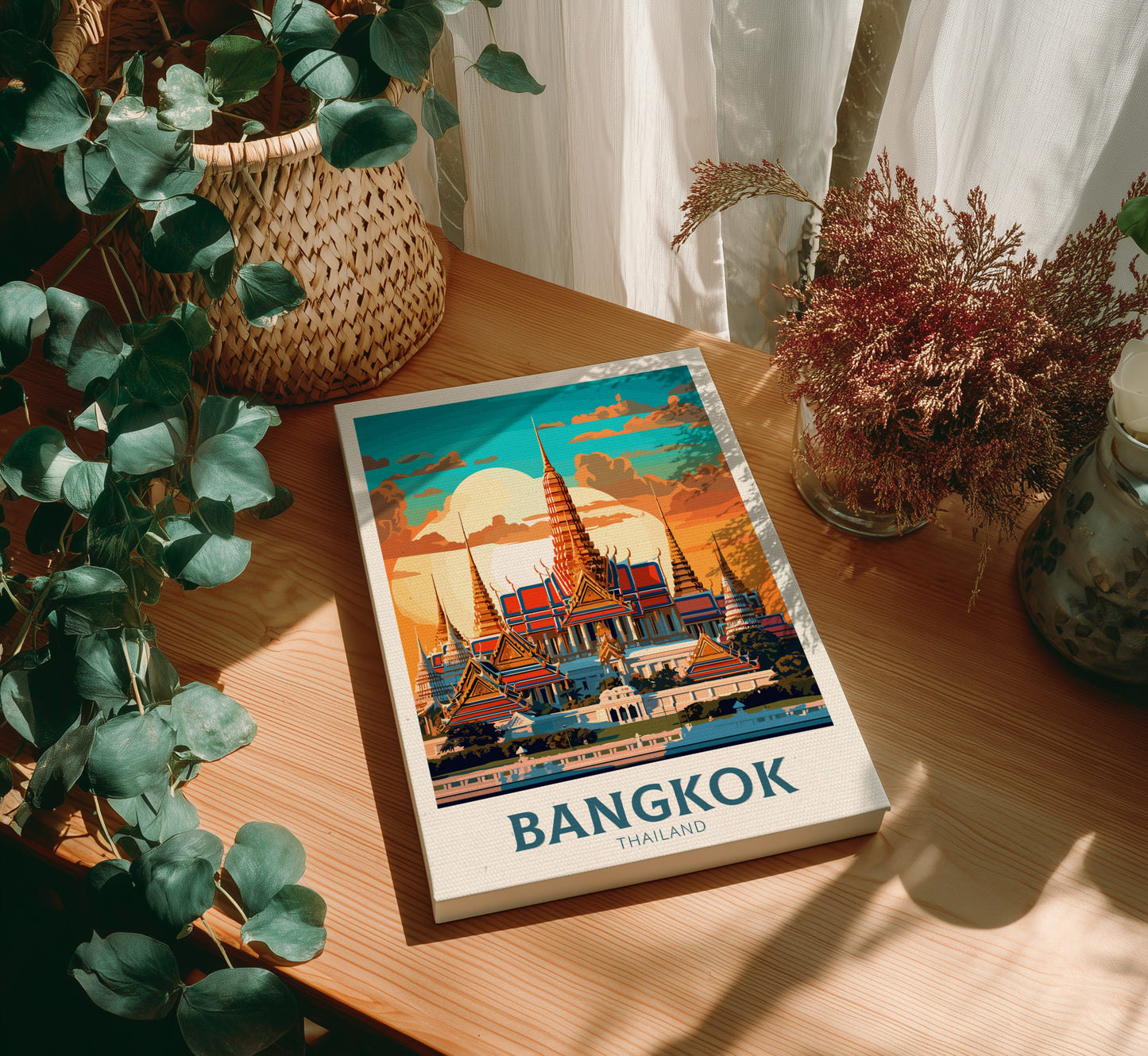 Canvas with a Bangkok illustration on a wooden table with plants
