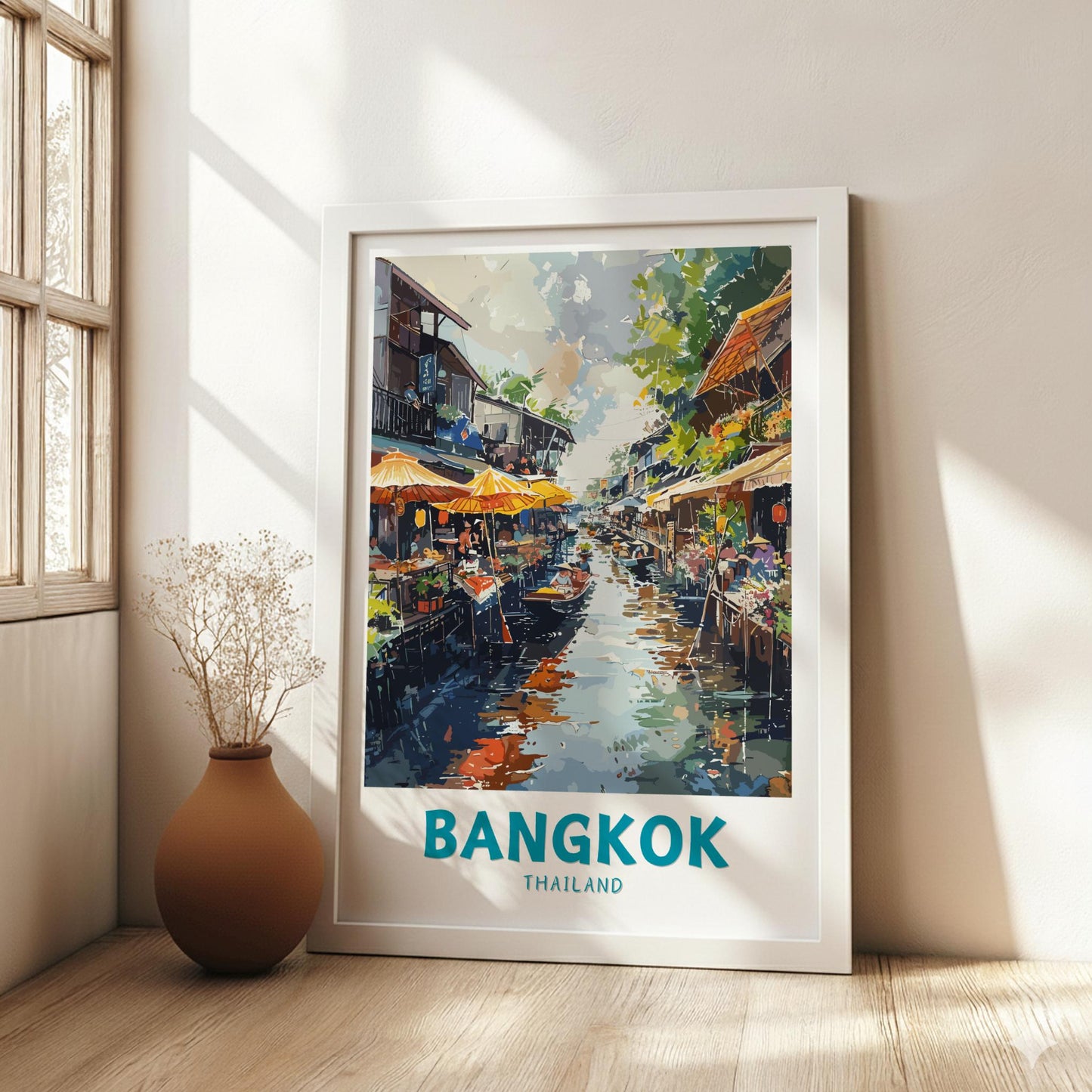 Framed artwork of a Bangkok street scene on a wall in a bright room.