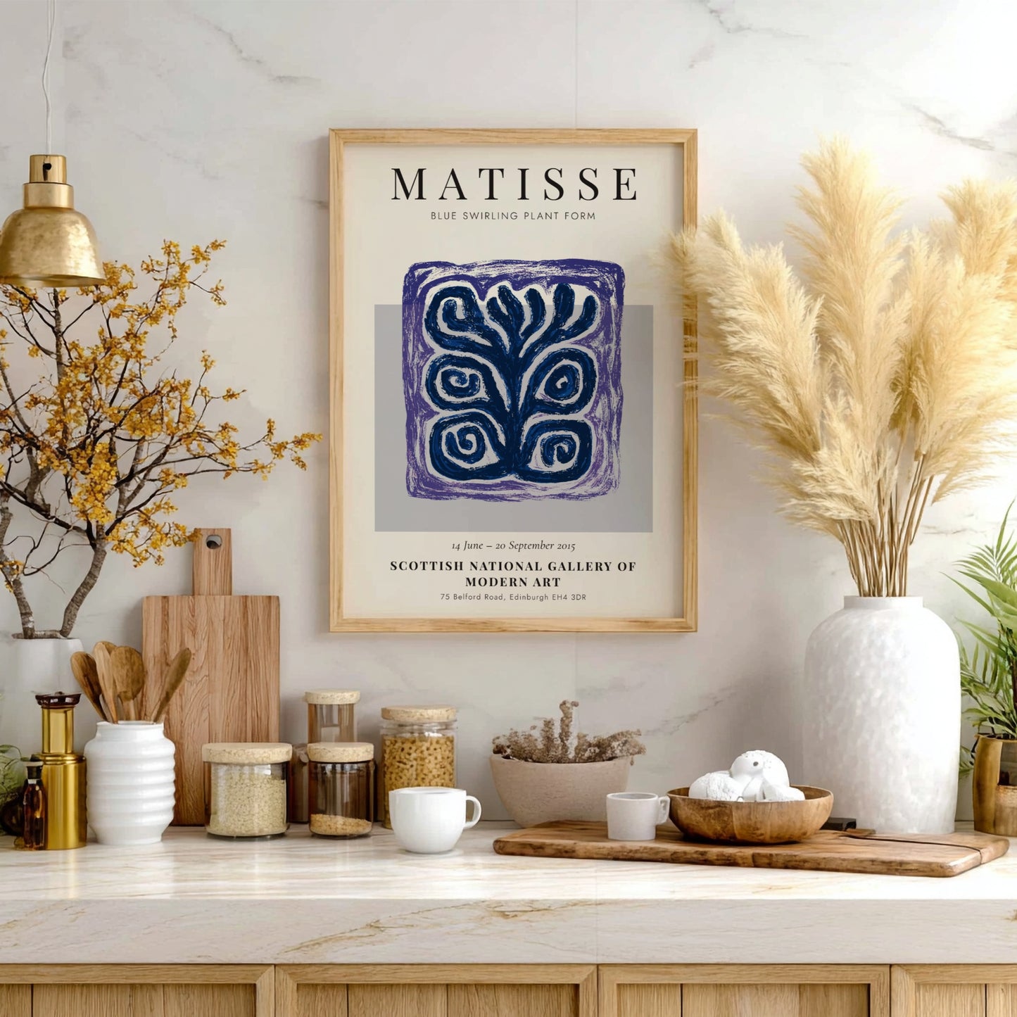 Framed Matisse artwork on a wall with decorative items below