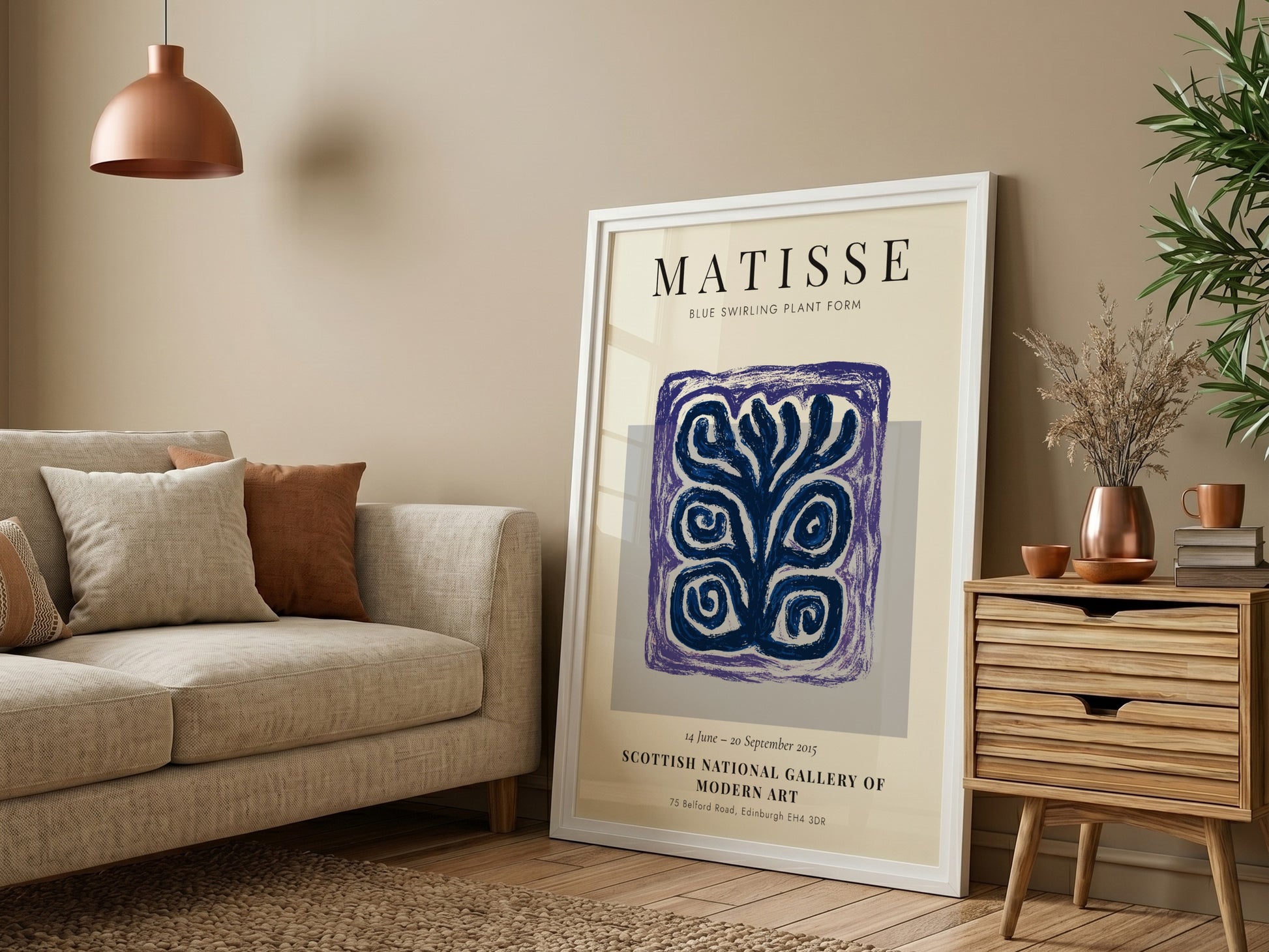 Framed Matisse art print in a living room setting with a couch and decor.