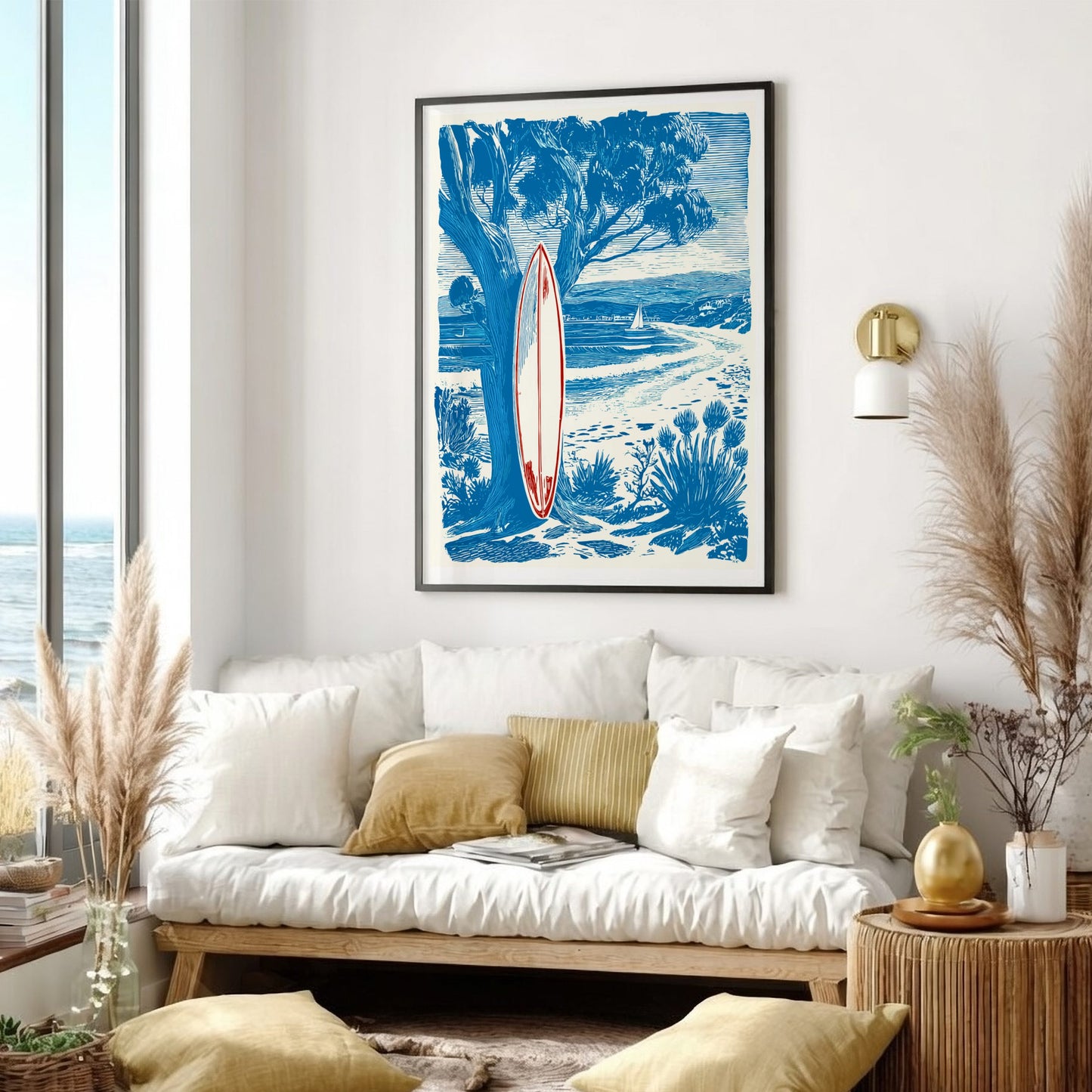 Living room with a white sofa, decorative pillows, and a framed artwork of a beach scene with a surfboard.
