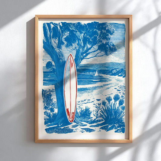 Framed artwork of a surfboard leaning against a tree with a beach scene in the background.