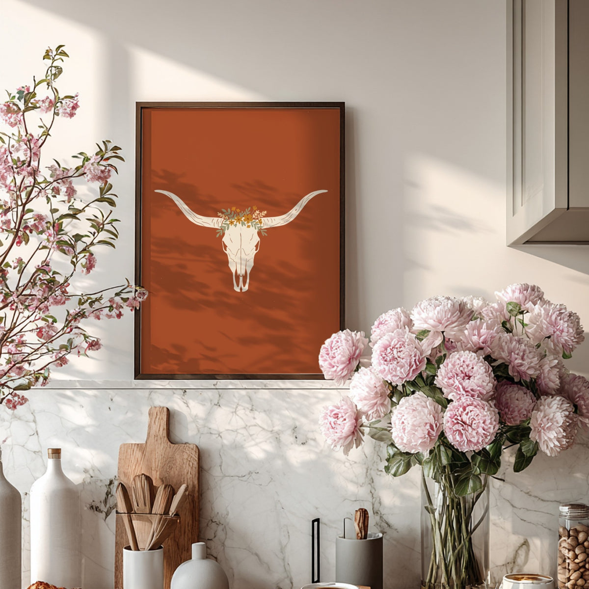 Poster featuring a white bull skull with a wildflower crown on terracotta background