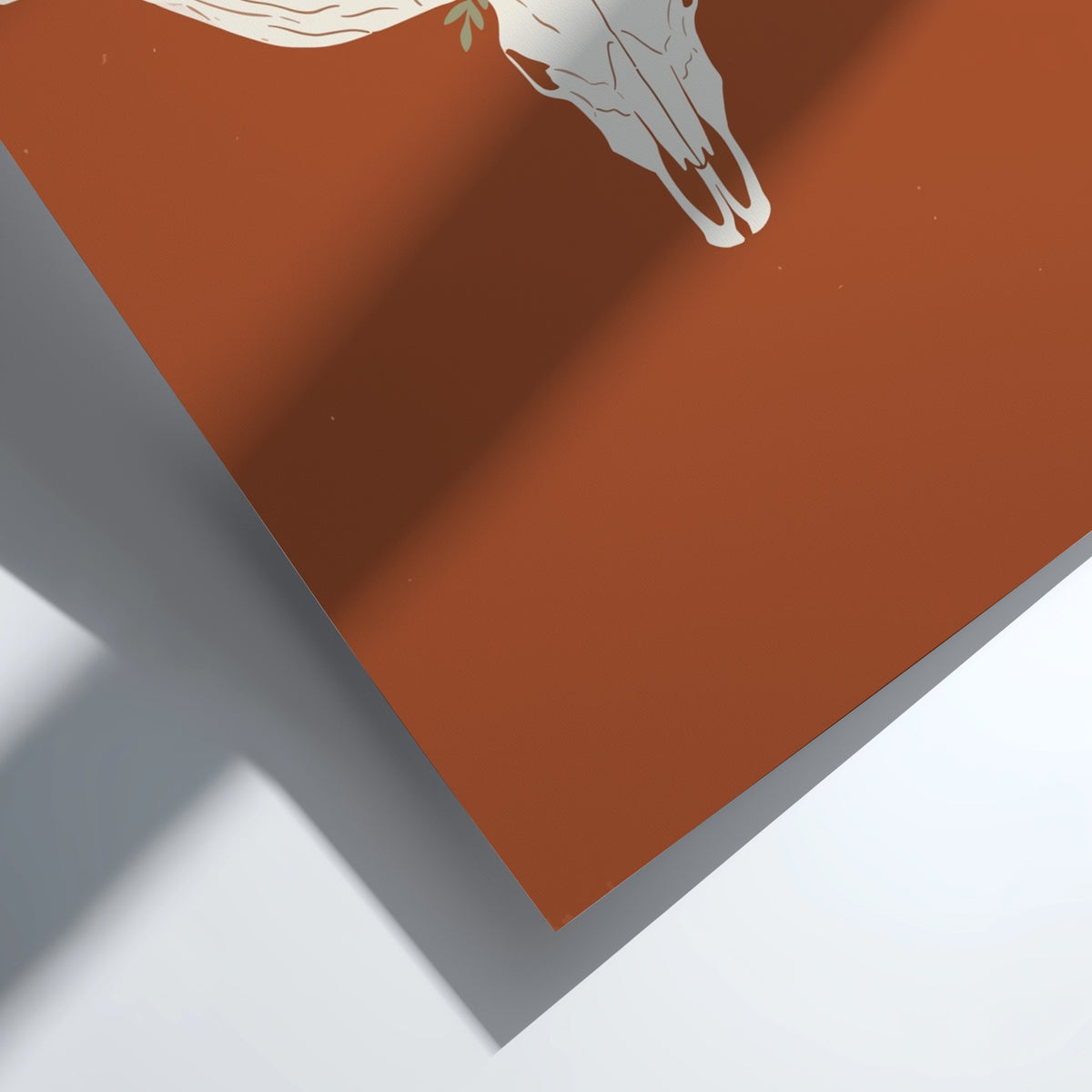 Poster featuring a white bull skull with a wildflower crown on terracotta background