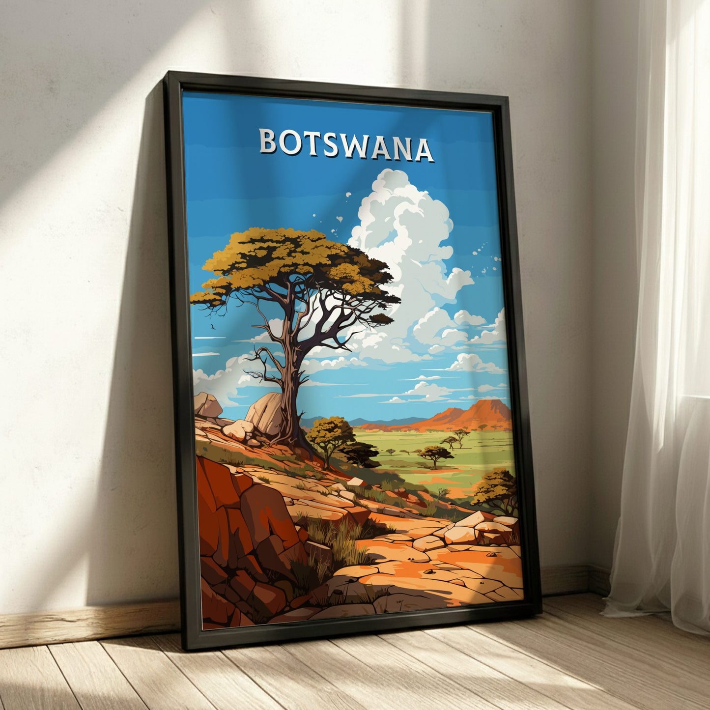 Framed artwork of a landscape with 'Botswana' text, featuring trees and rocks.