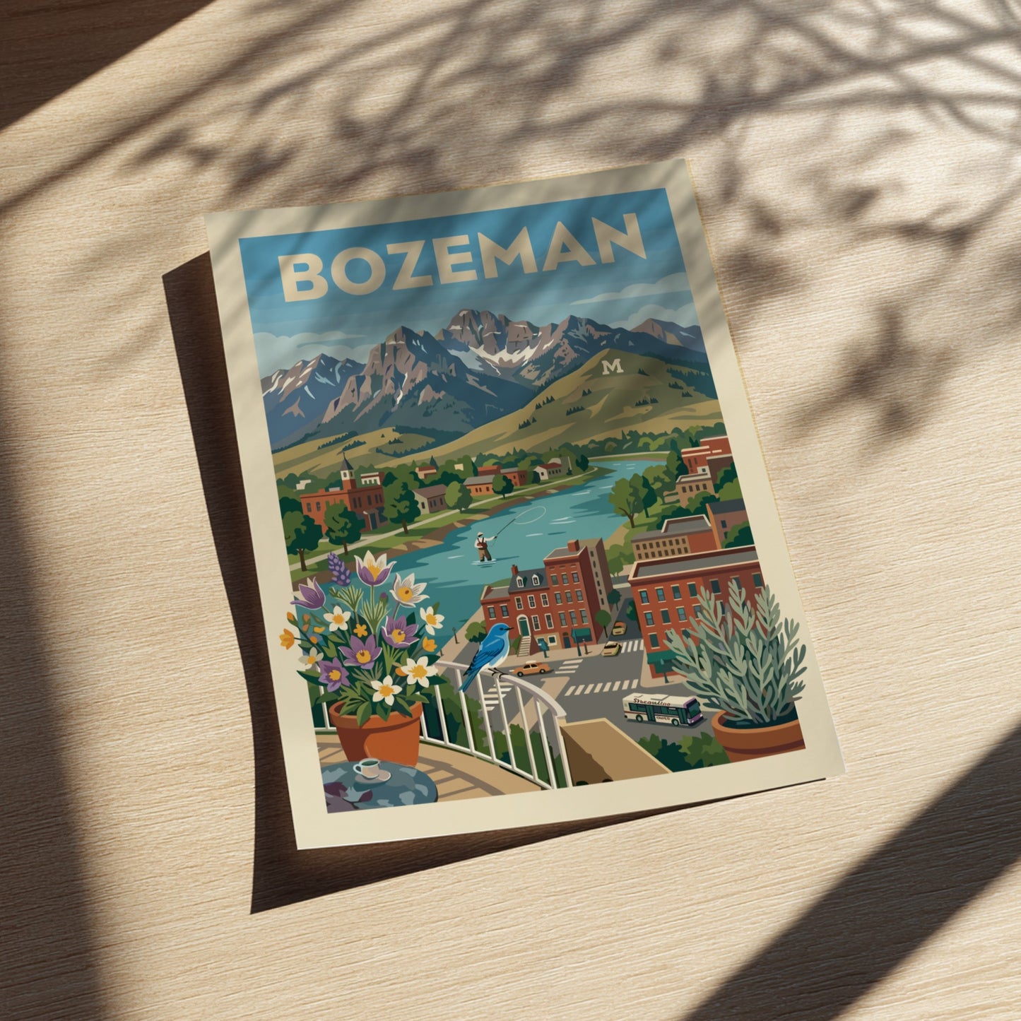 Bozeman mountain town travel poster featuring a river, mountains, and buildings in a retro art style.