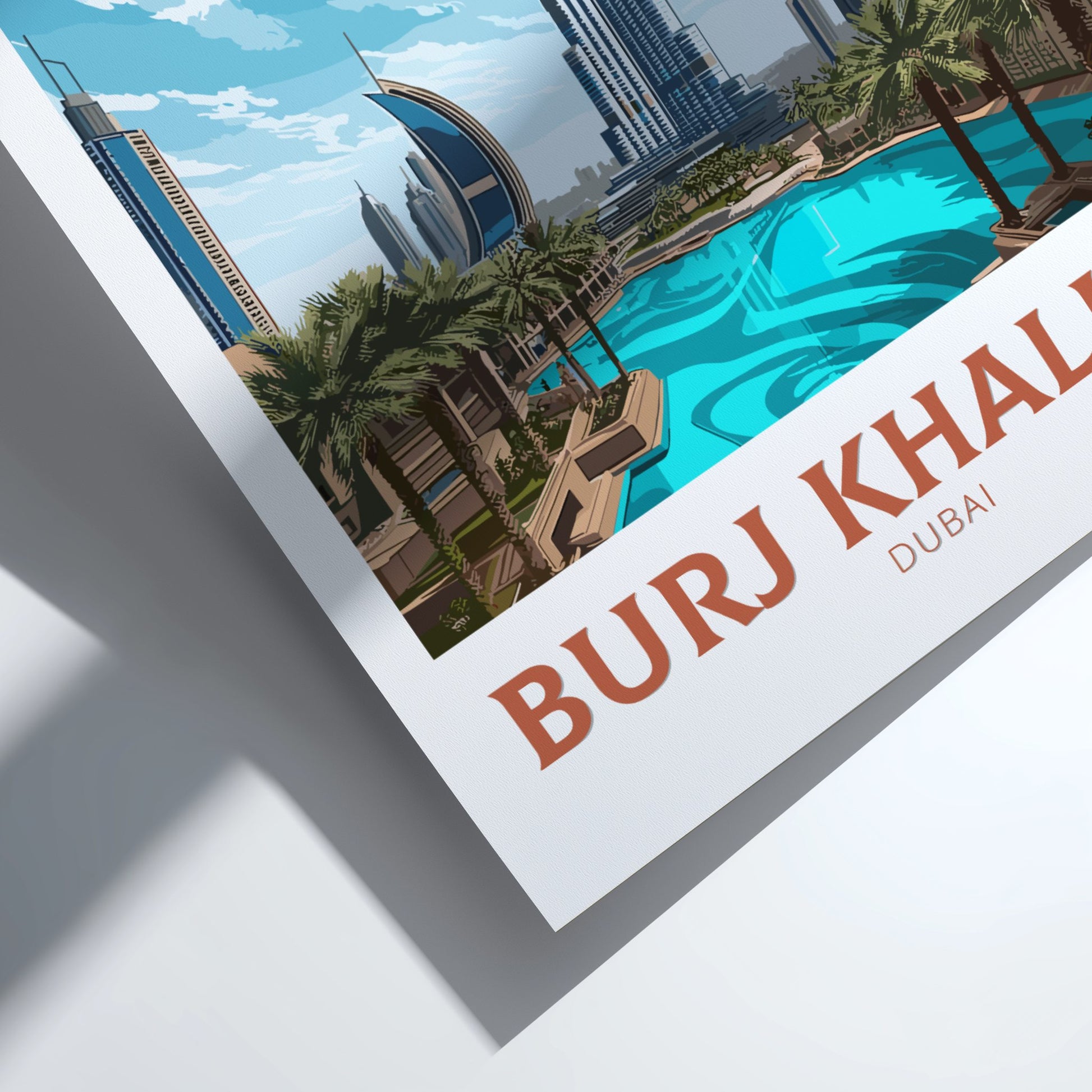 Framed poster of Burj Khalifa with a pool and chairs in the background