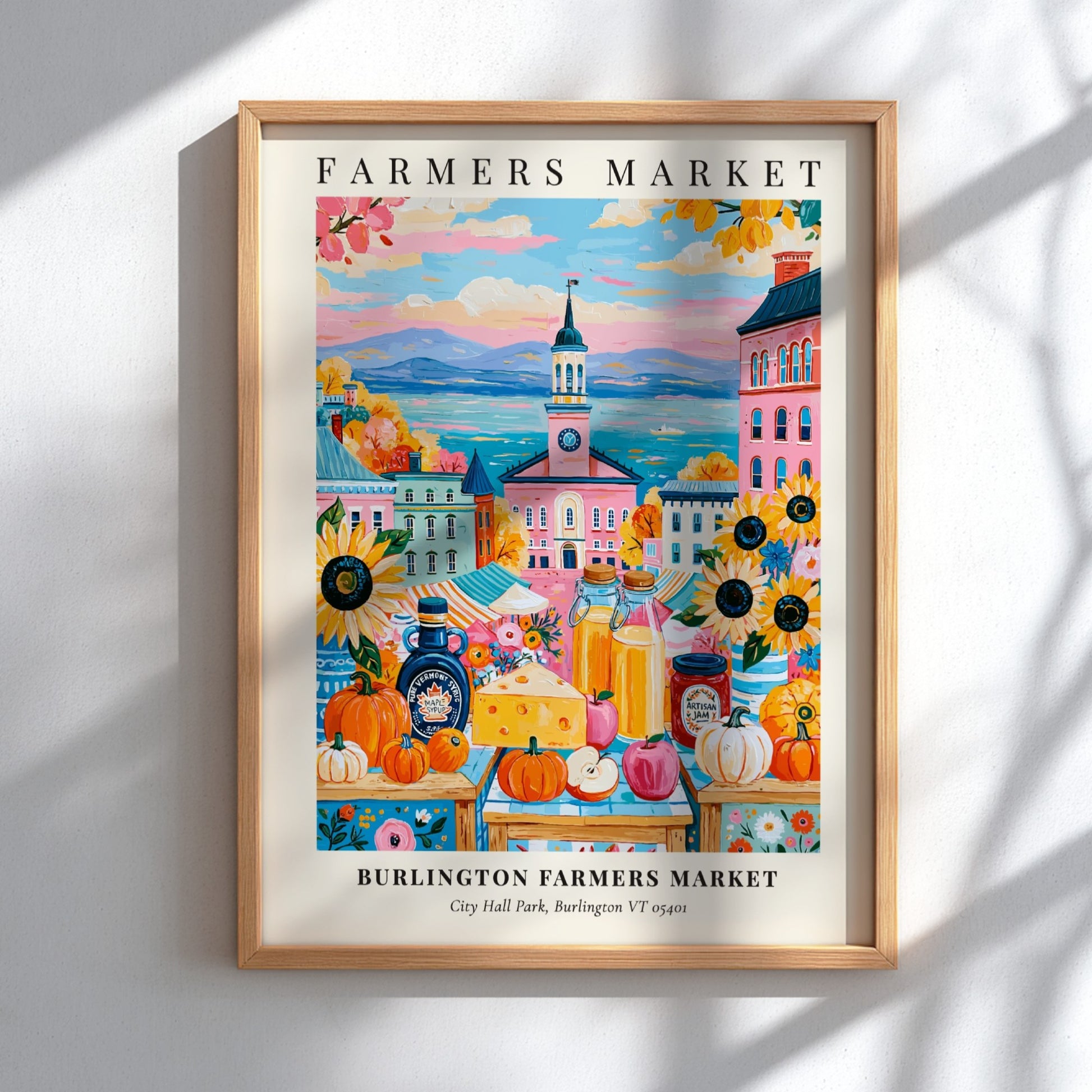 Burlington Farmers Market poster featuring colorful pumpkins and city backdrop in warm tones