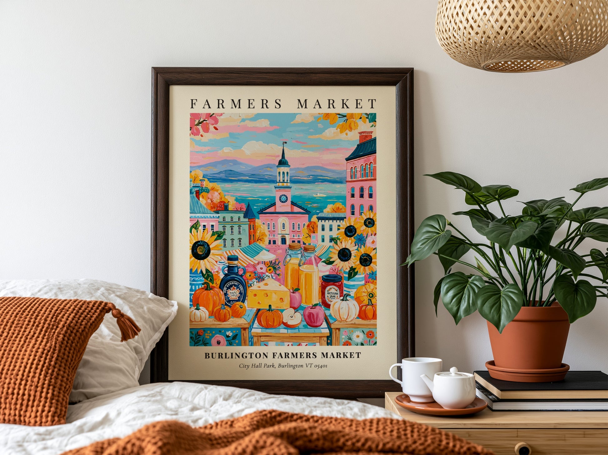 Burlington Farmers Market poster featuring colorful pumpkins and city backdrop in warm tones