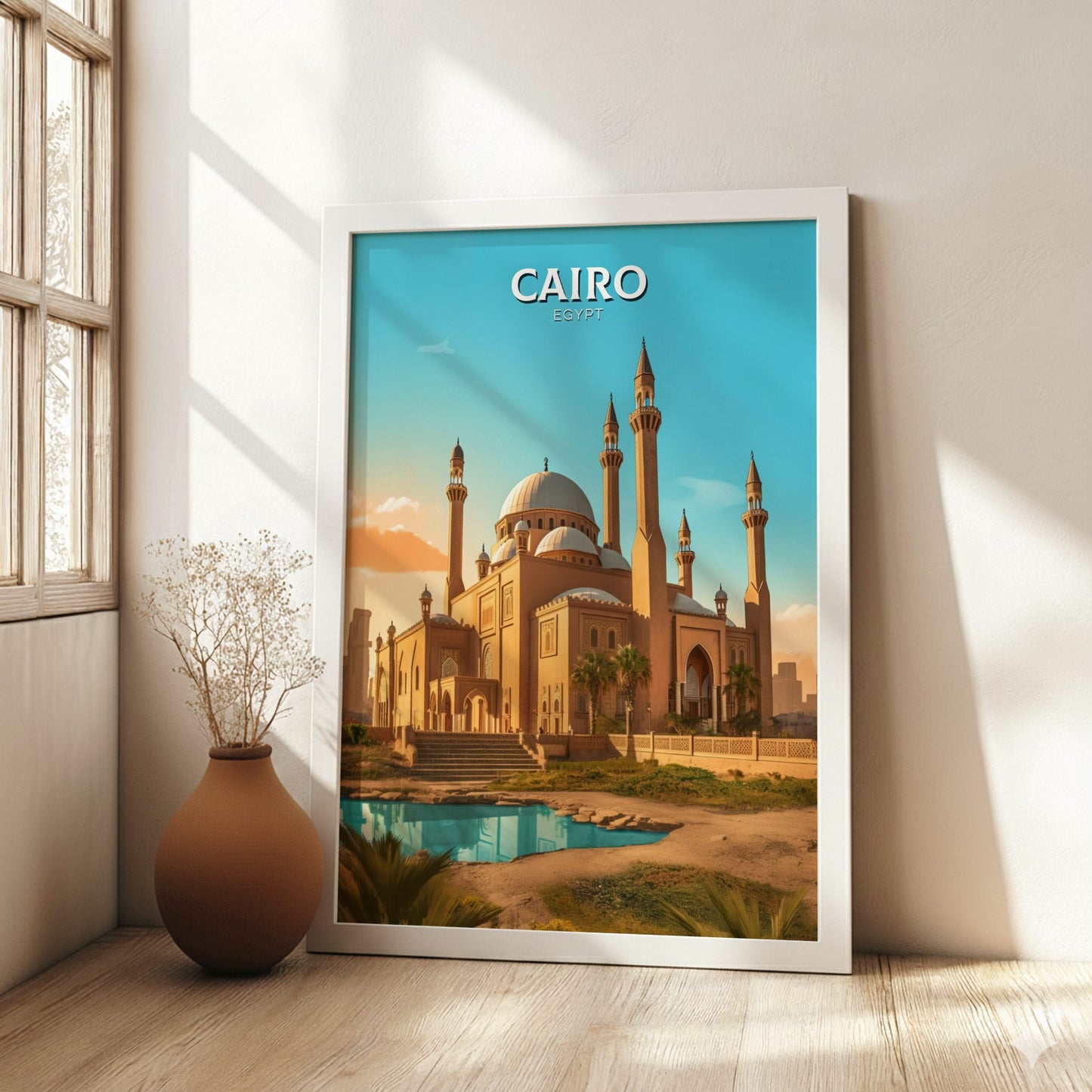 Framed poster of a mosque in Cairo on a wall in a bright room.