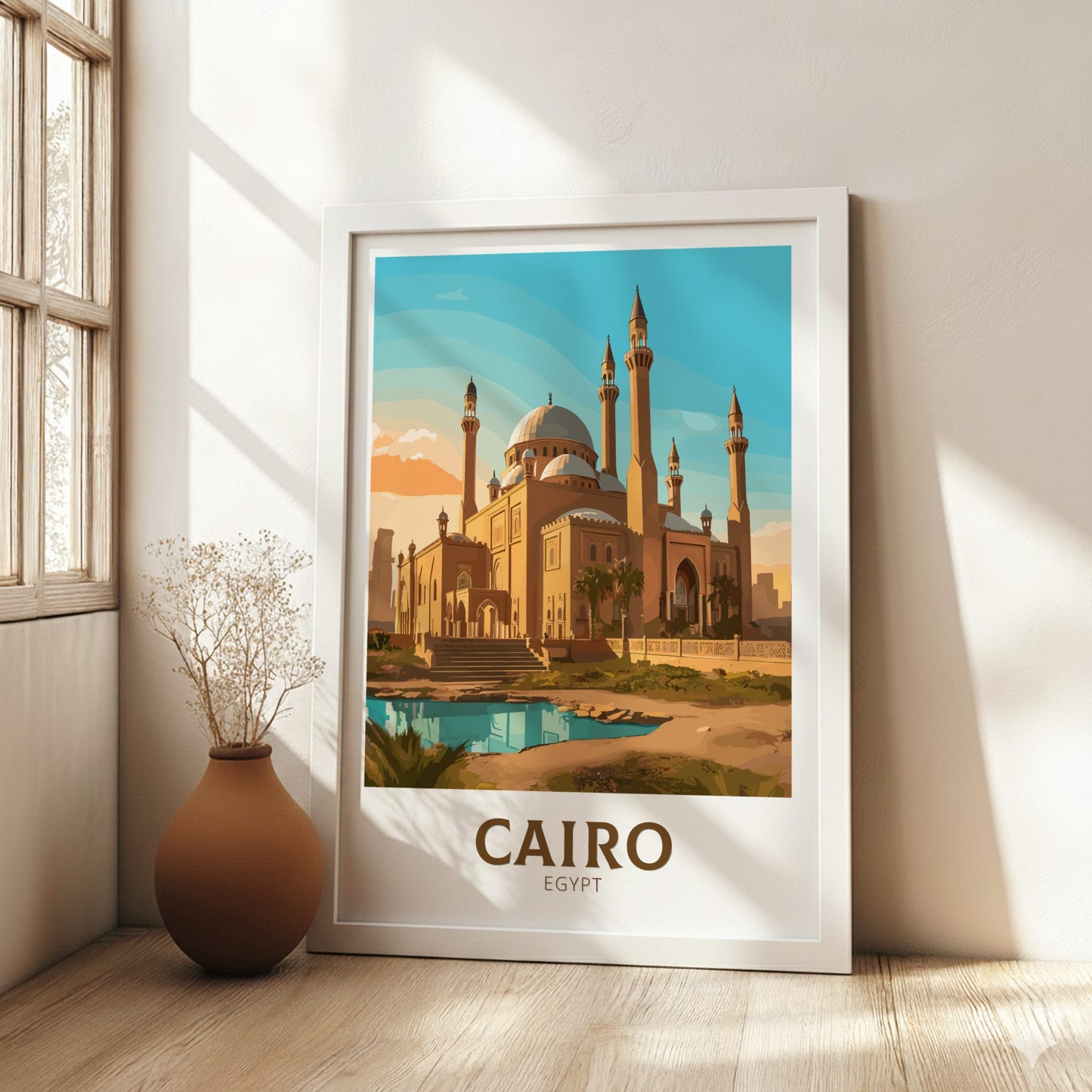 Framed poster of a mosque in Cairo, Egypt, on a wall in a bright room with a vase.