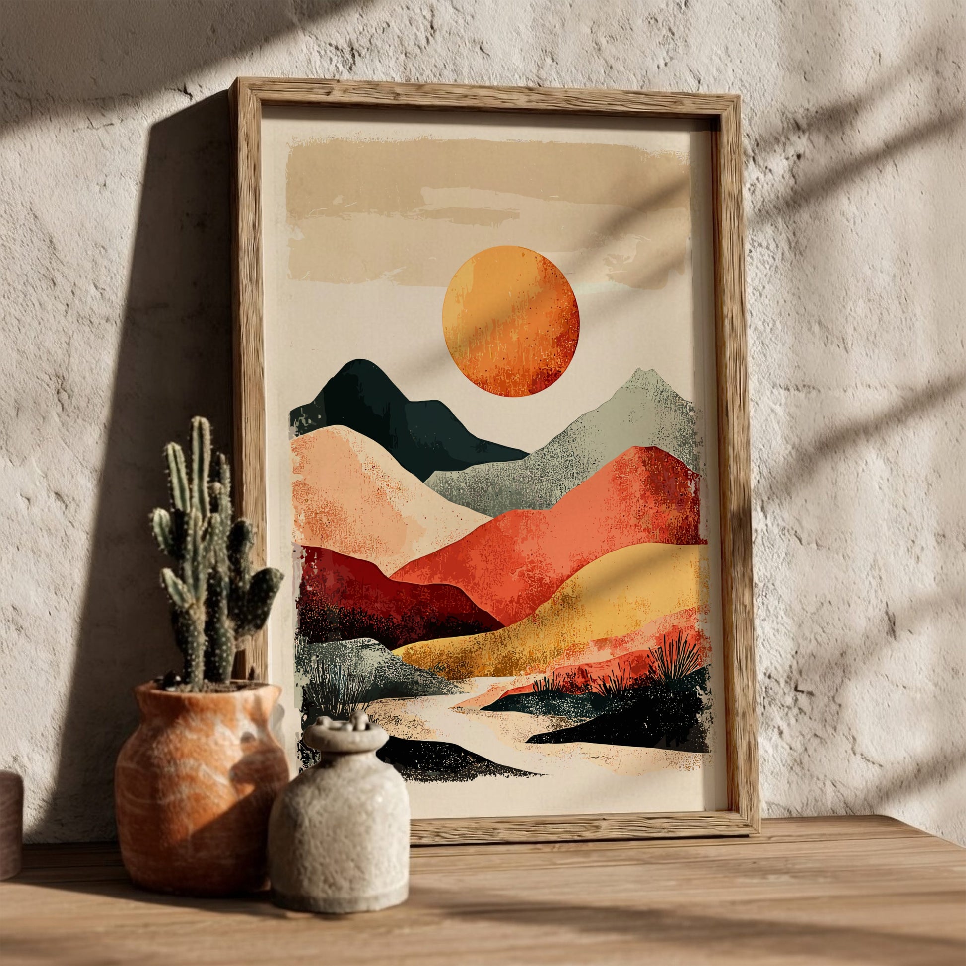 Framed abstract landscape art with a sun and mountains on a textured wall.