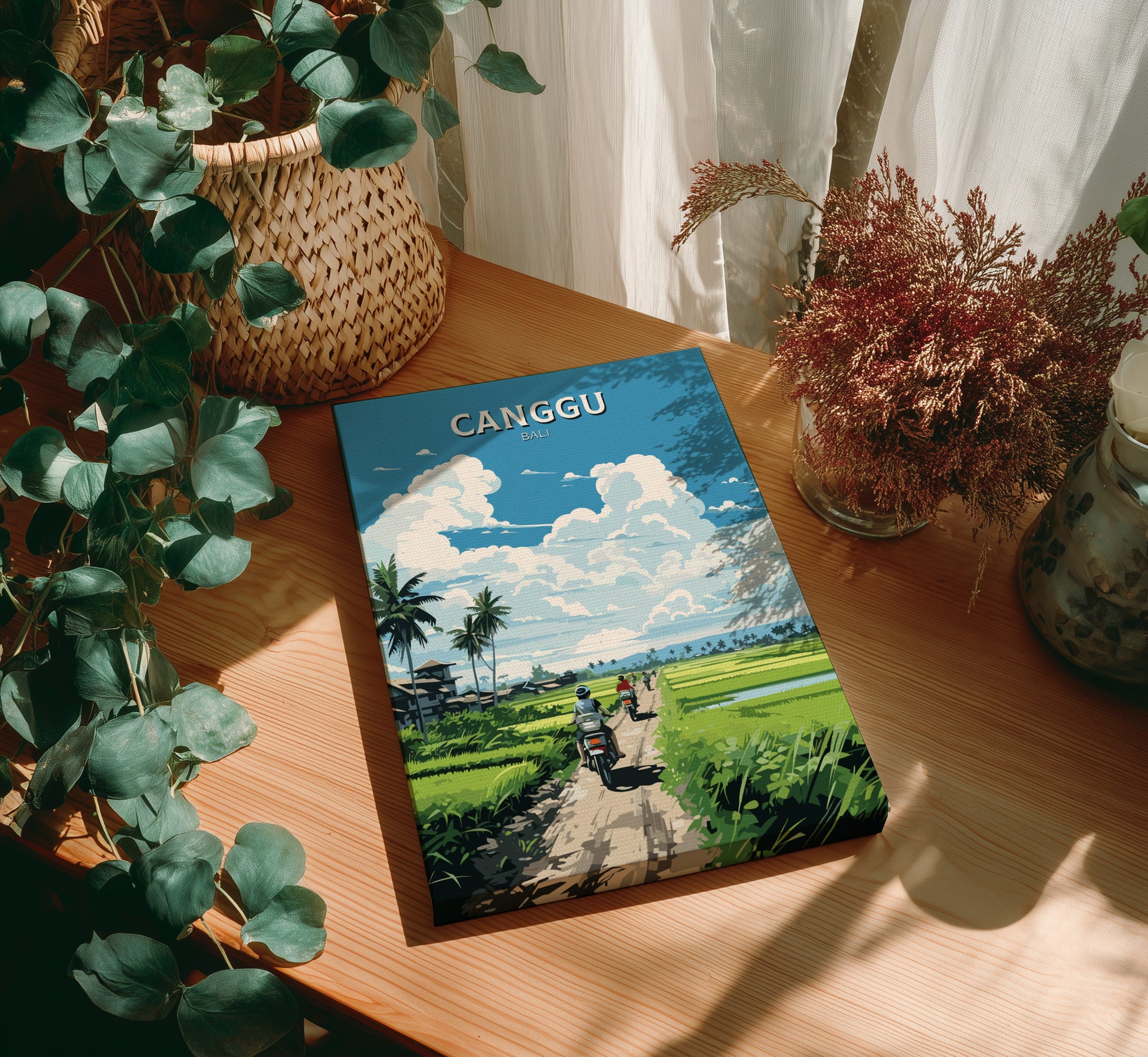 Book titled 'Canggu' on a wooden table with plants around