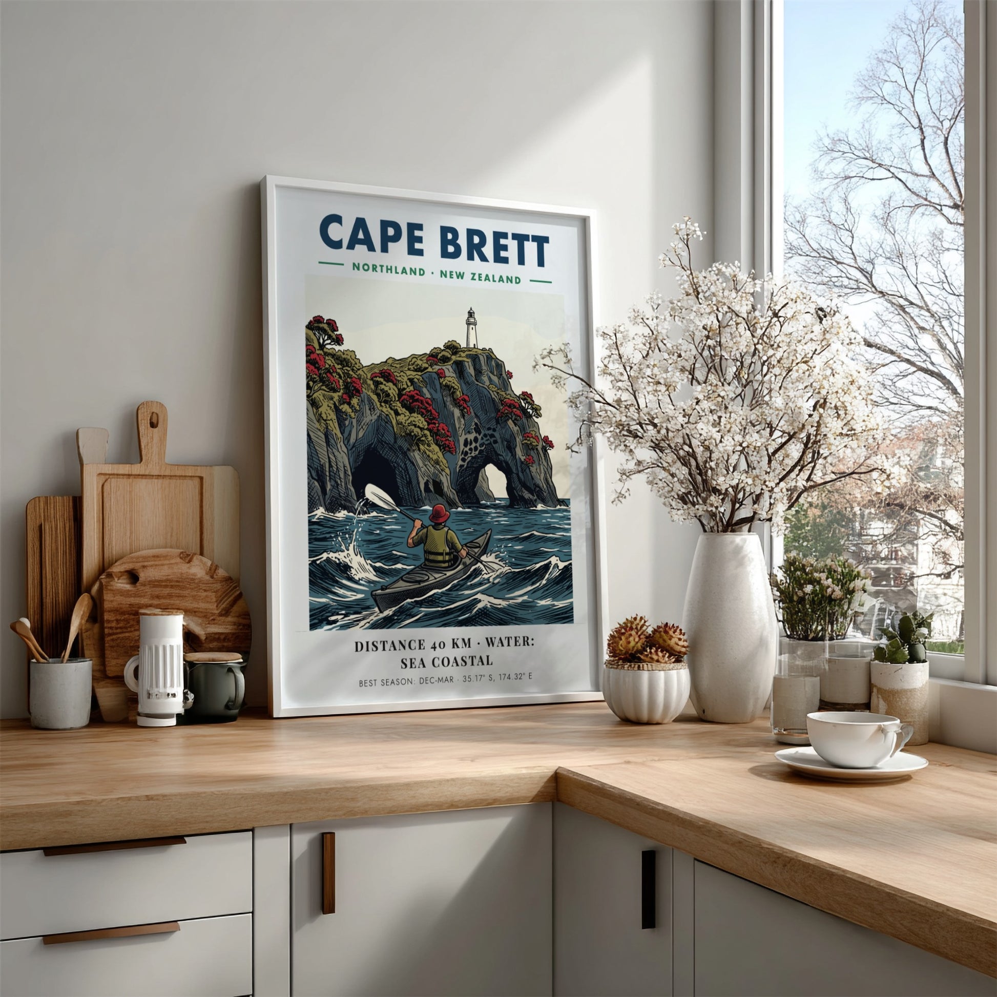 Poster of a kayaker paddling near the dramatic cliffs and lighthouse at Cape Brett.