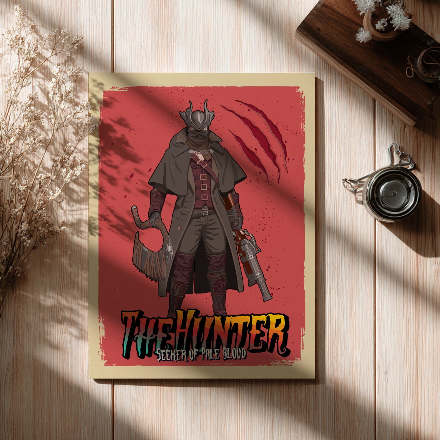 Poster of The Hunter from Bloodborne on a wooden surface with a cup and plant.