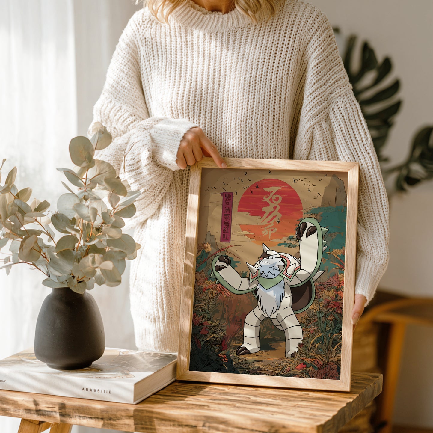 Person holding a framed artwork of a stylized Chesnaught Pokemon character with a sunset background