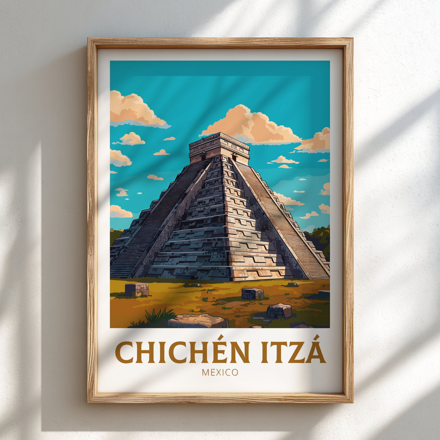 Framed artwork of Chichén Itzó pyramid with a wooden frame on a white wall.