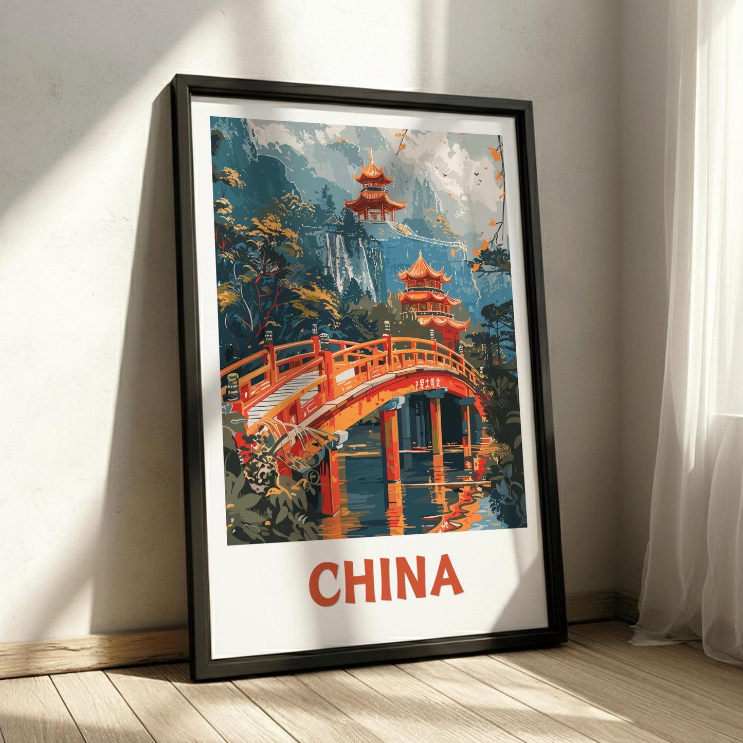 Framed artwork of a Chinese landscape with pagodas and a bridge, labeled 'China', on a light wooden floor.