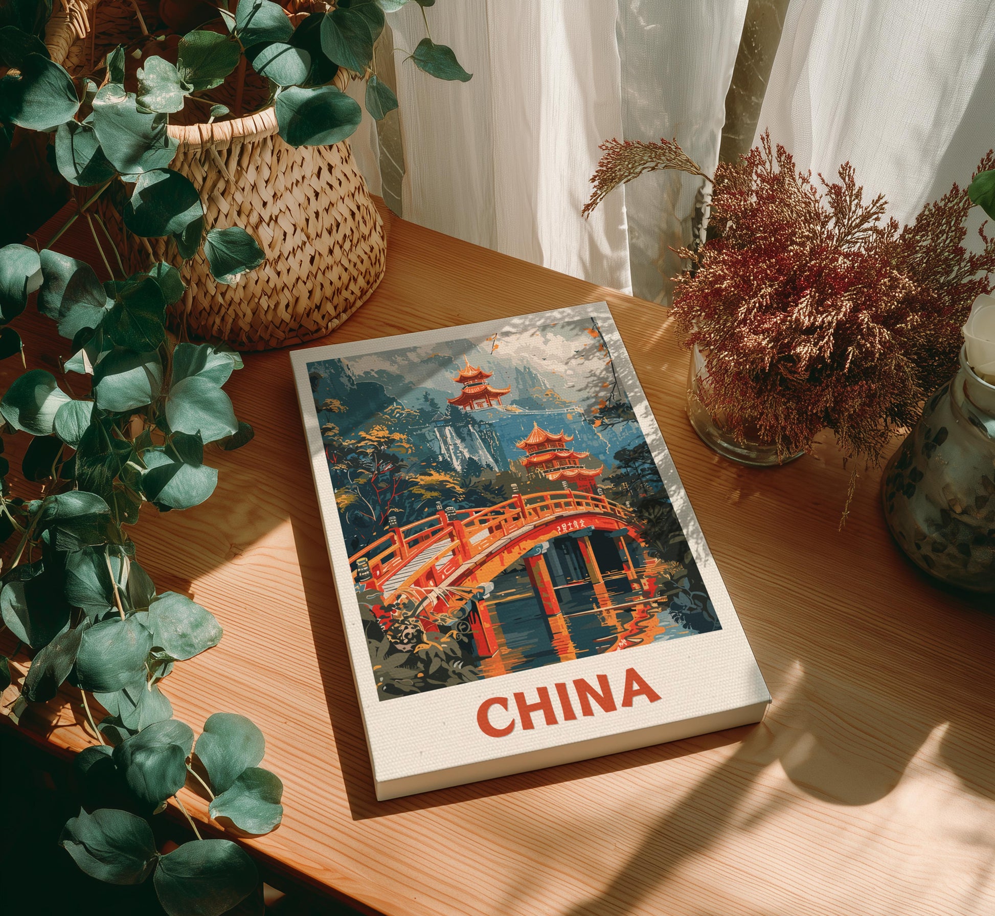 Canvas of 'China' with a scenic cover on a wooden table surrounded by plants