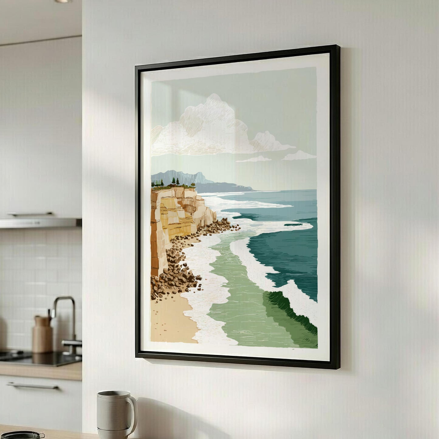 Framed artwork of a coastal scene on a wall in a kitchen.