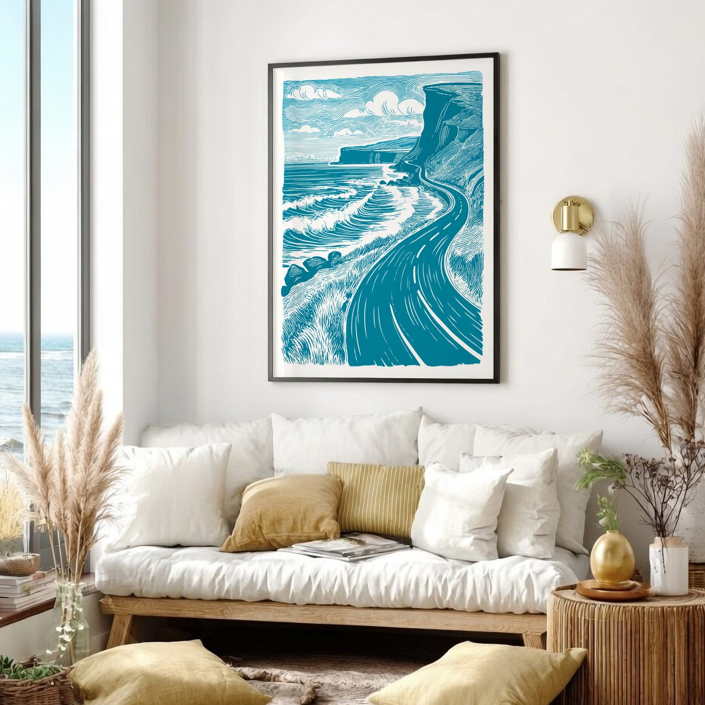 Living room with a white sofa, decorative pillows, and a large framed artwork of a coastal scene.