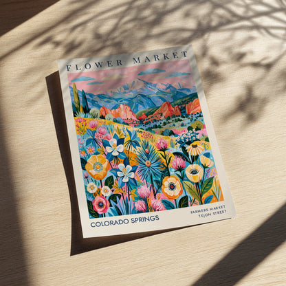 Colorado Springs flower market poster featuring vibrant flowers and mountains in a colorful design