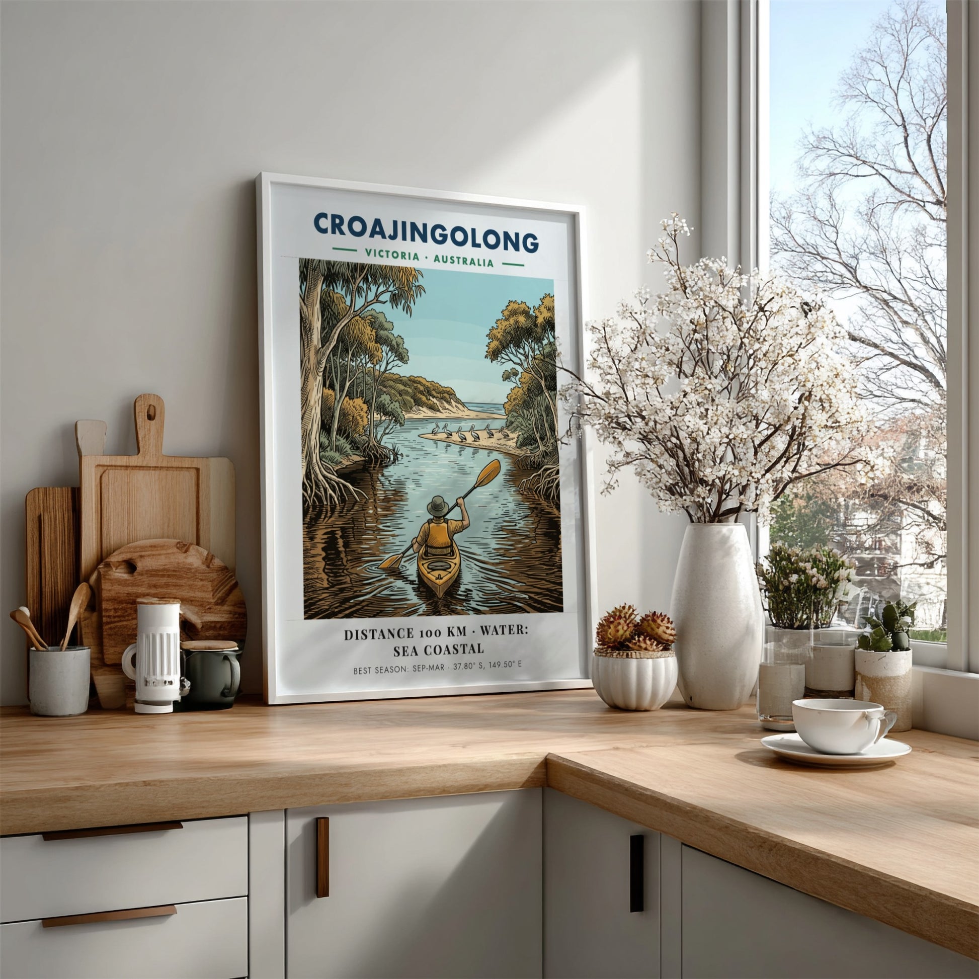 Poster featuring a person kayaking through Croajingolong, Victoria, with pelicans on a beach.