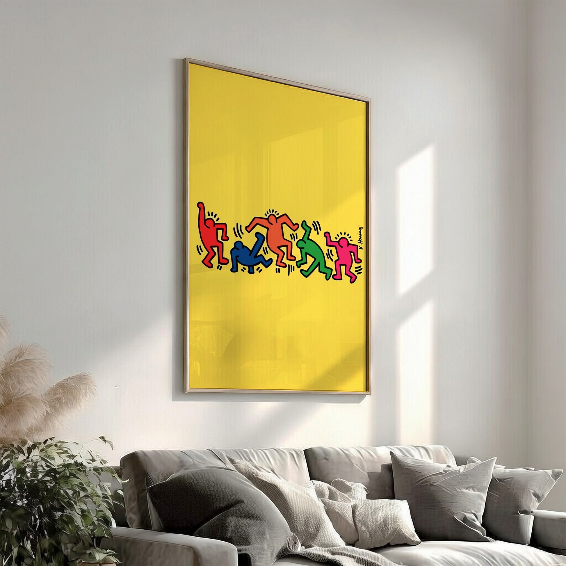 Keith Haring "Dancing Figures" poster with colorful figures on a yellow background.