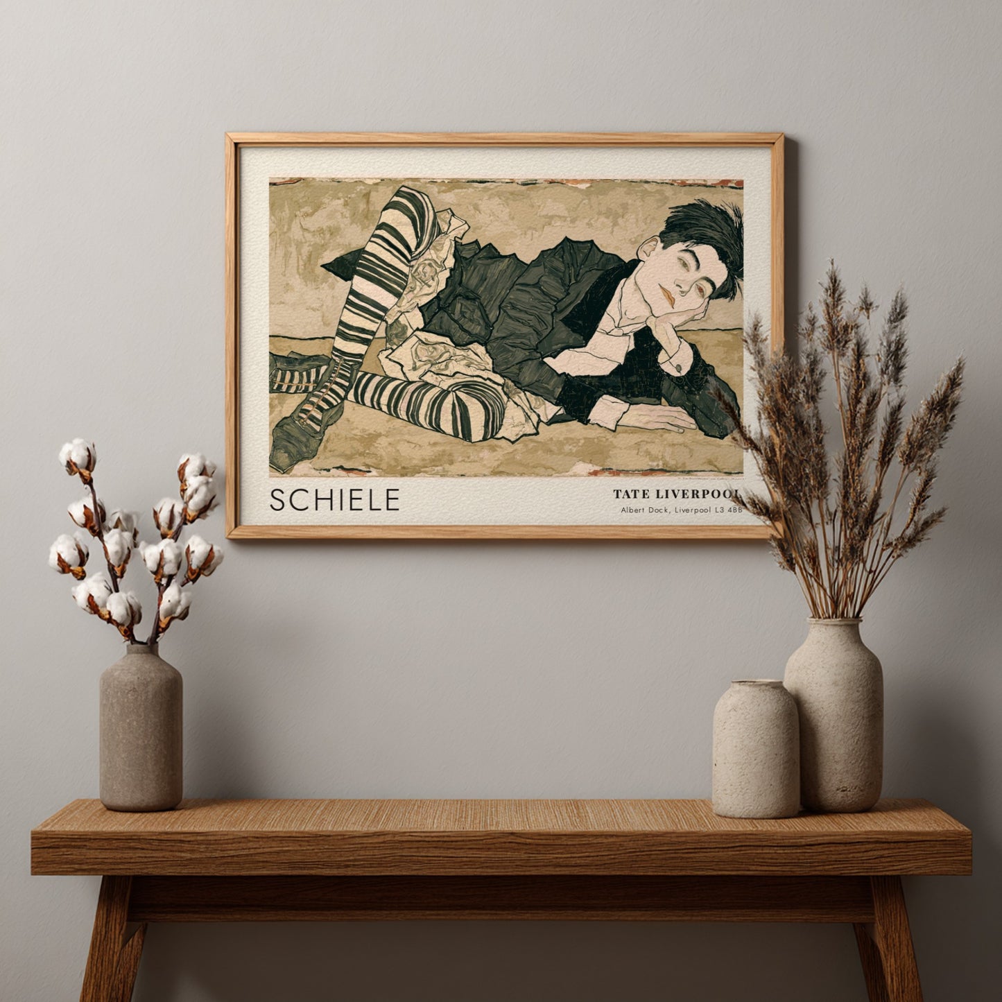 Wall art poster featuring an Egon Schiele portrait with striped stockings and text.